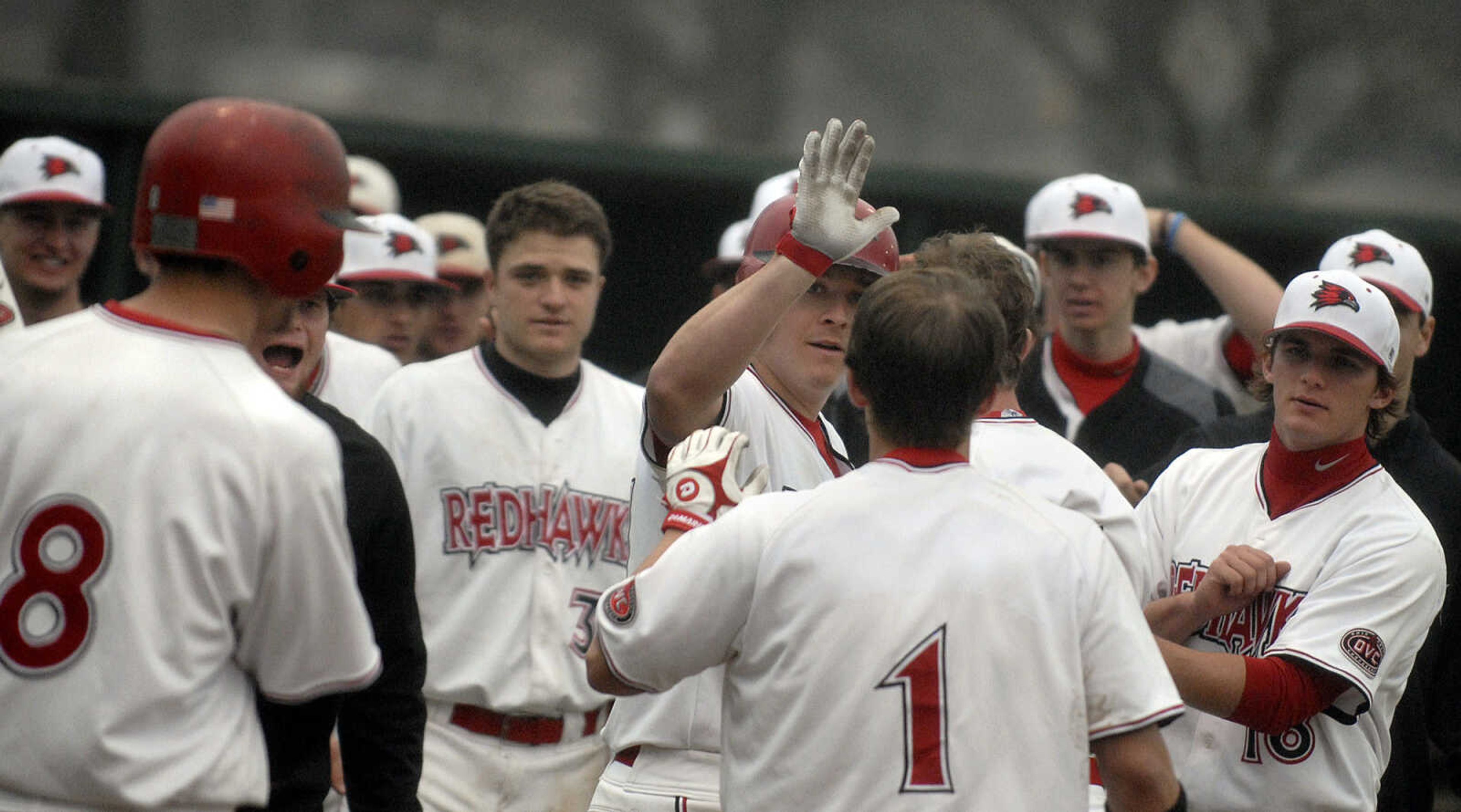 LAURA SIMON~lsimon@semissourian.com
Southeast players congratulate teammate Michael Adamson on his three run homer in the fourth inning against Ball State Sunday, February 27, 2011 at Capaha Field. Southeast defeated Ball State 22-8.