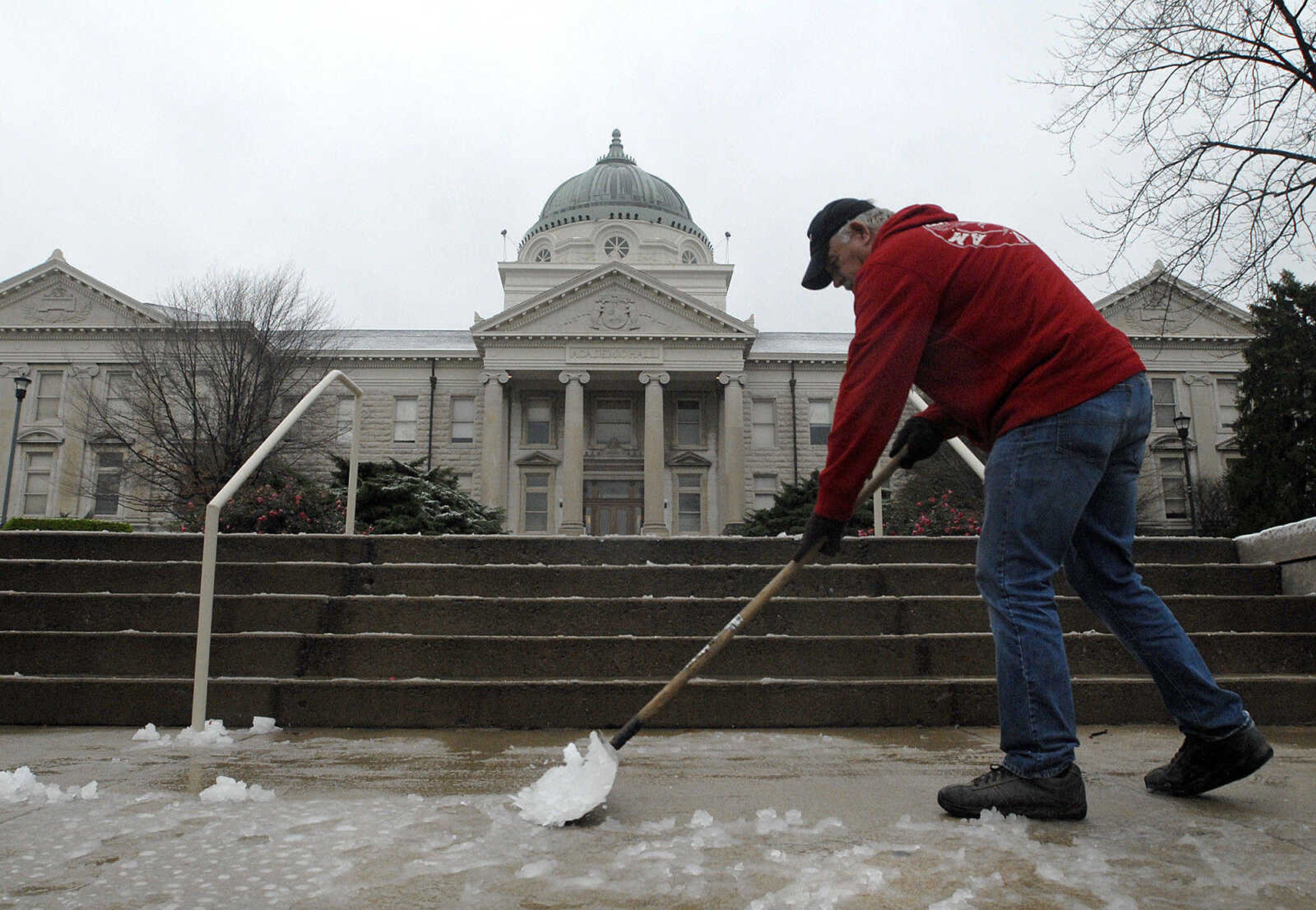 Tom Bowen with Southeast Missouri State University facilities management shovels Cape Girardeau's first wintery mix of the season off the steps in front of Academic Hall Tuesday morning, November 29, 2011. (Laura Simon)