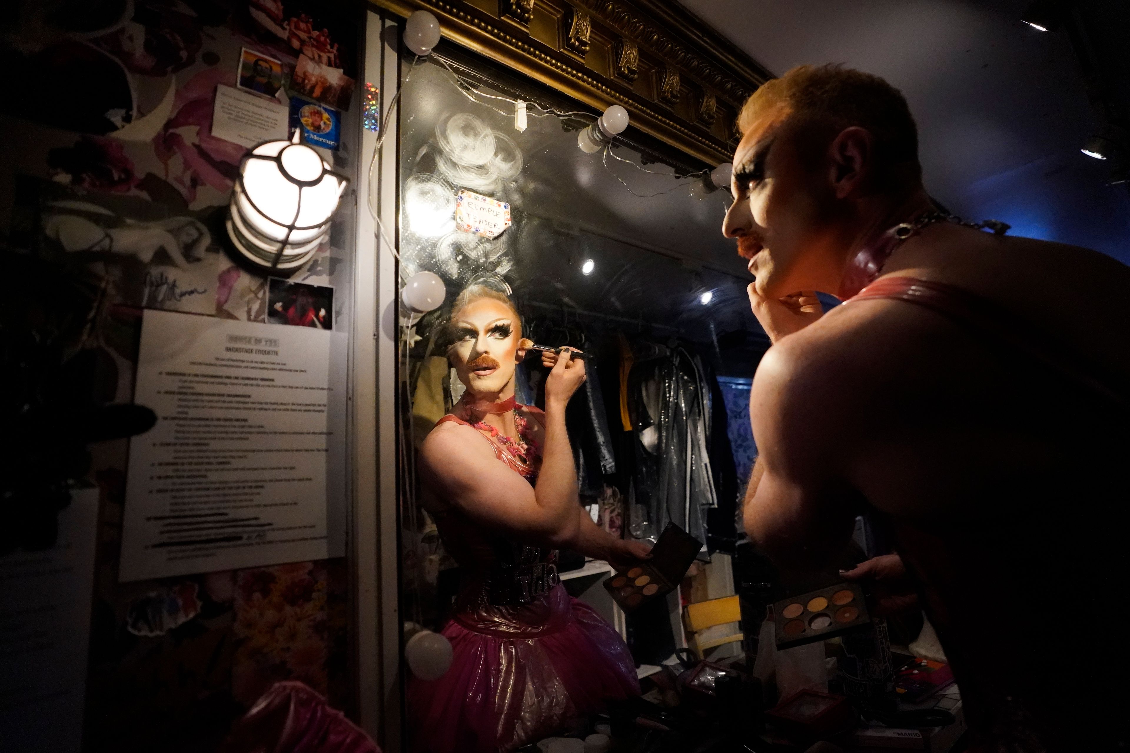 Pattie Gonia applies makeup ahead of performing at the "Save Her! Environmental Drag Show" during Climate Week, Tuesday, Sept. 24, 2024, in the Brooklyn borough of New York. (AP Photo/Alyssa Goodman)