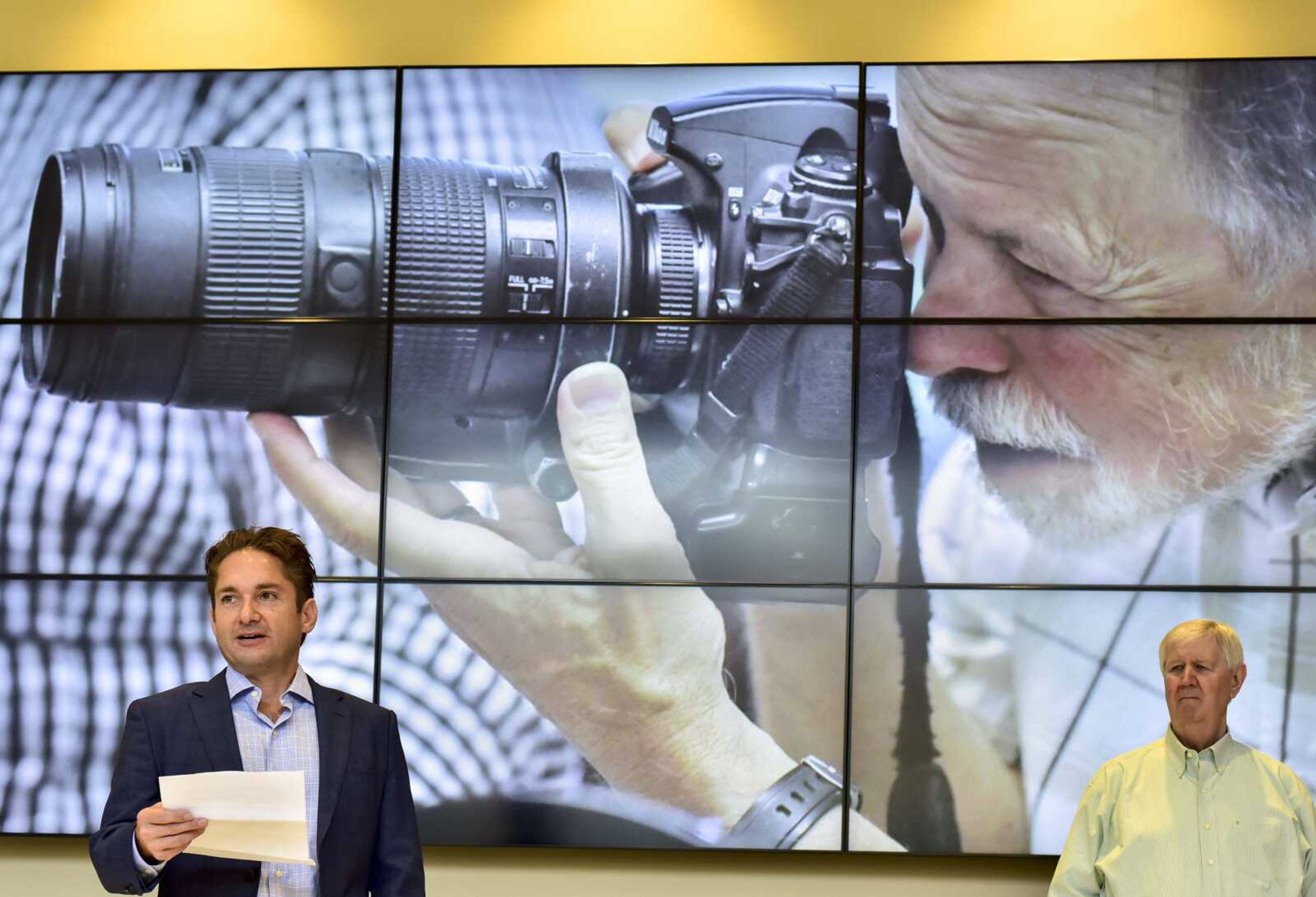 Joe Sullivan, far right, retired editor of the Southeast Missourian, listens as Jon K. Rust, publisher of the Southeast Missourian and co-president of Rust Communications, delivers a speech during a retirement party for Fred Lynch (not pictured) on Friday, Aug. 24, 2018 in the Bullpen at the Rust Center for Media in Cape Girardeau.