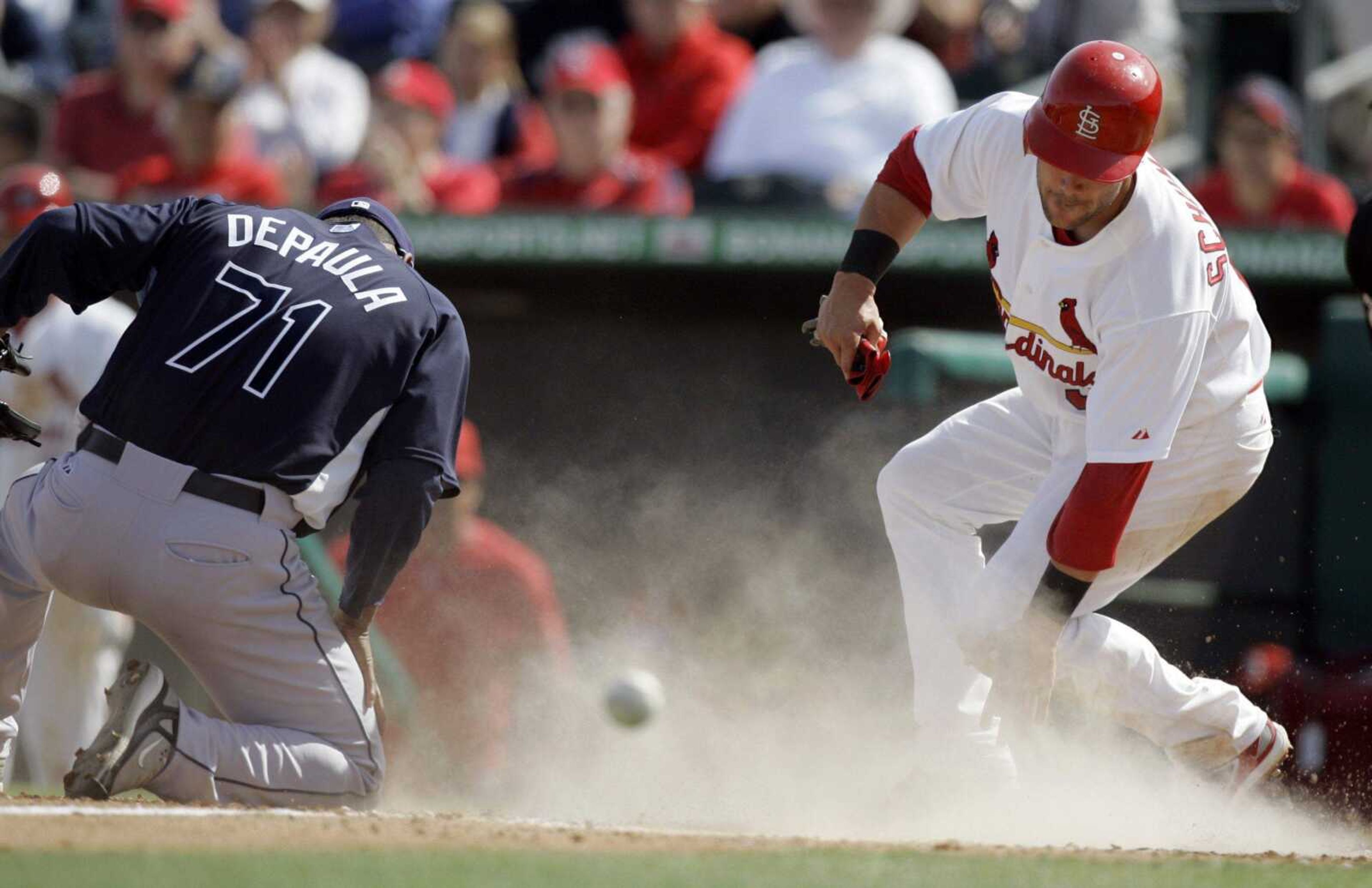 St. Louis Cardinals' Skip Schumaker, right, gets up after scoring on a wild pitch by Tampa Bay Rays relief pitcher Julio DePaula, left, during the fifth inning of a spring training baseball game Monday, March 2, 2009, in Jupiter, Fla. (AP Photo/Jeff Roberson)