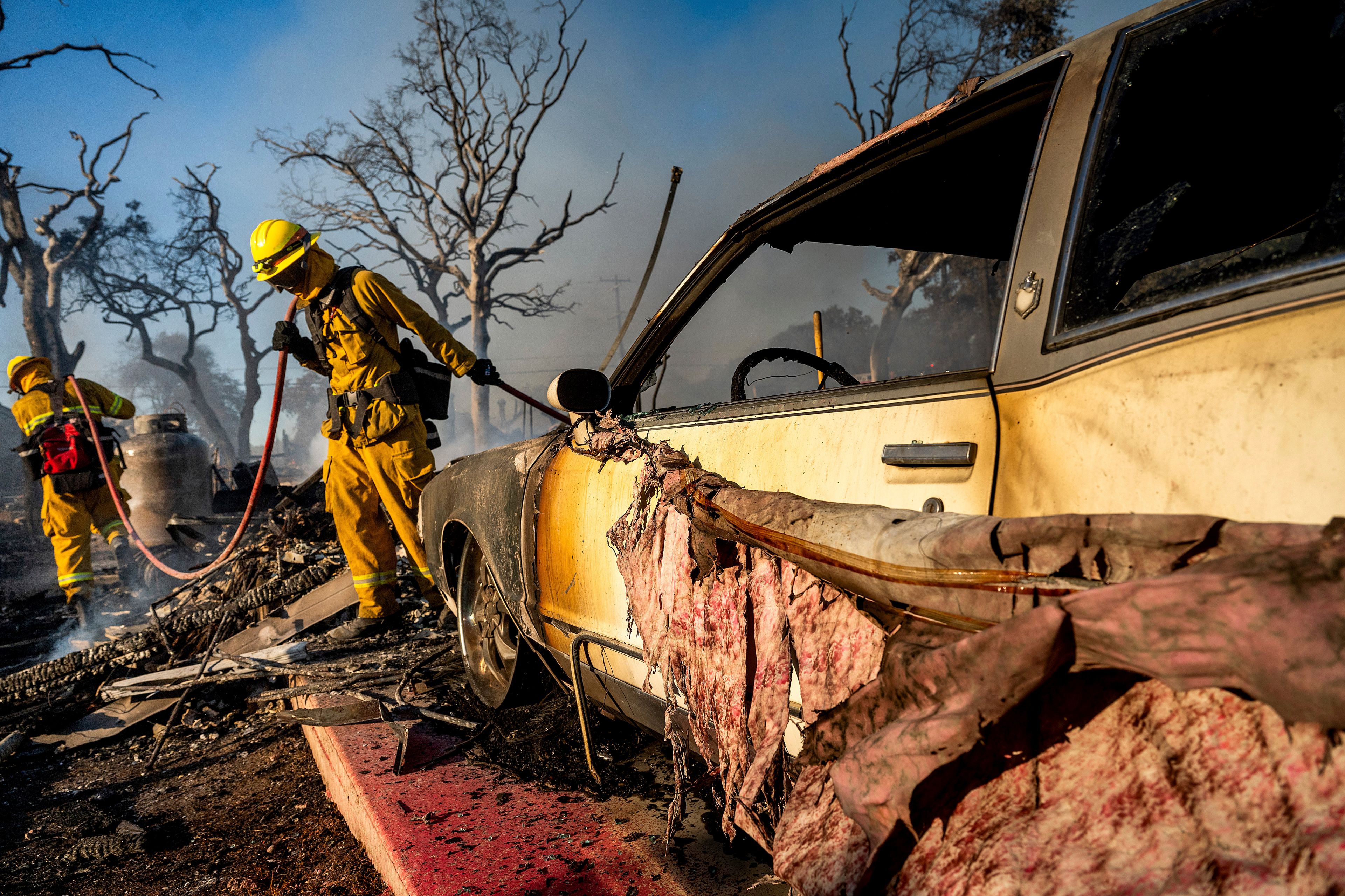 Firefighters extinguish hot spots as the Boyles fire burns in Clearlake, Calif., on Sunday, Sept. 8, 2024. (AP Photo/Noah Berger)