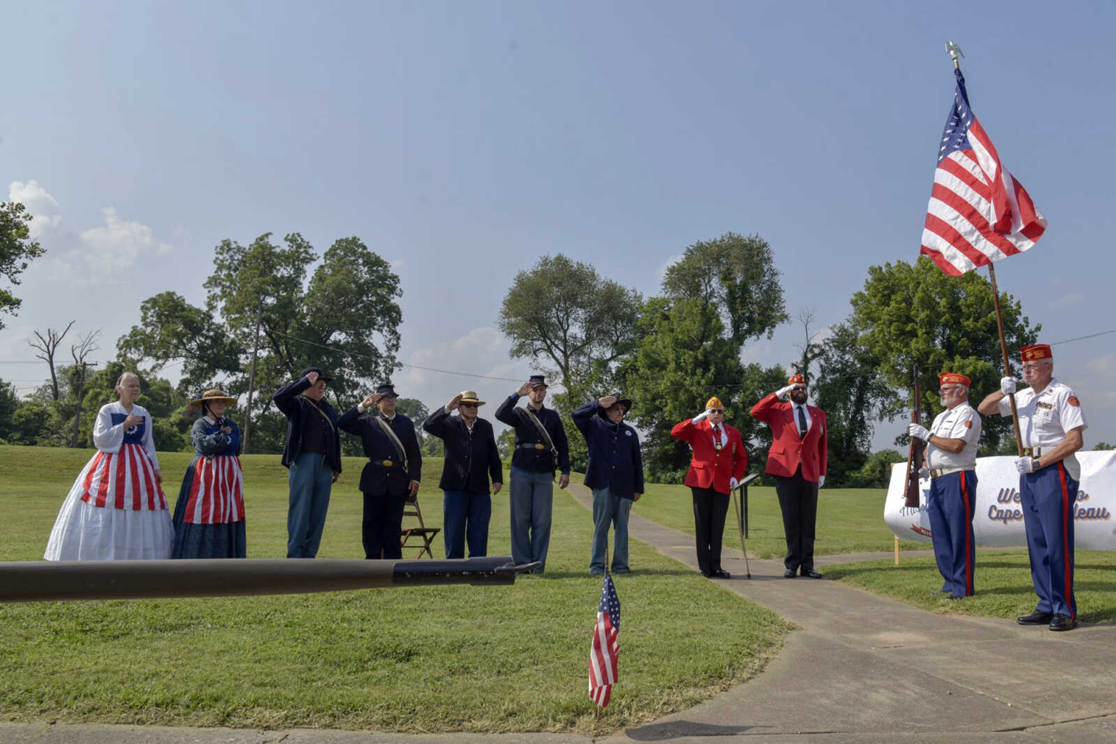 Those who work at Fort D salute the American flag during the governor's visit to Fort D Historic Site on Monday in Cape Girardeau as part of his state Bicentennial Tour.