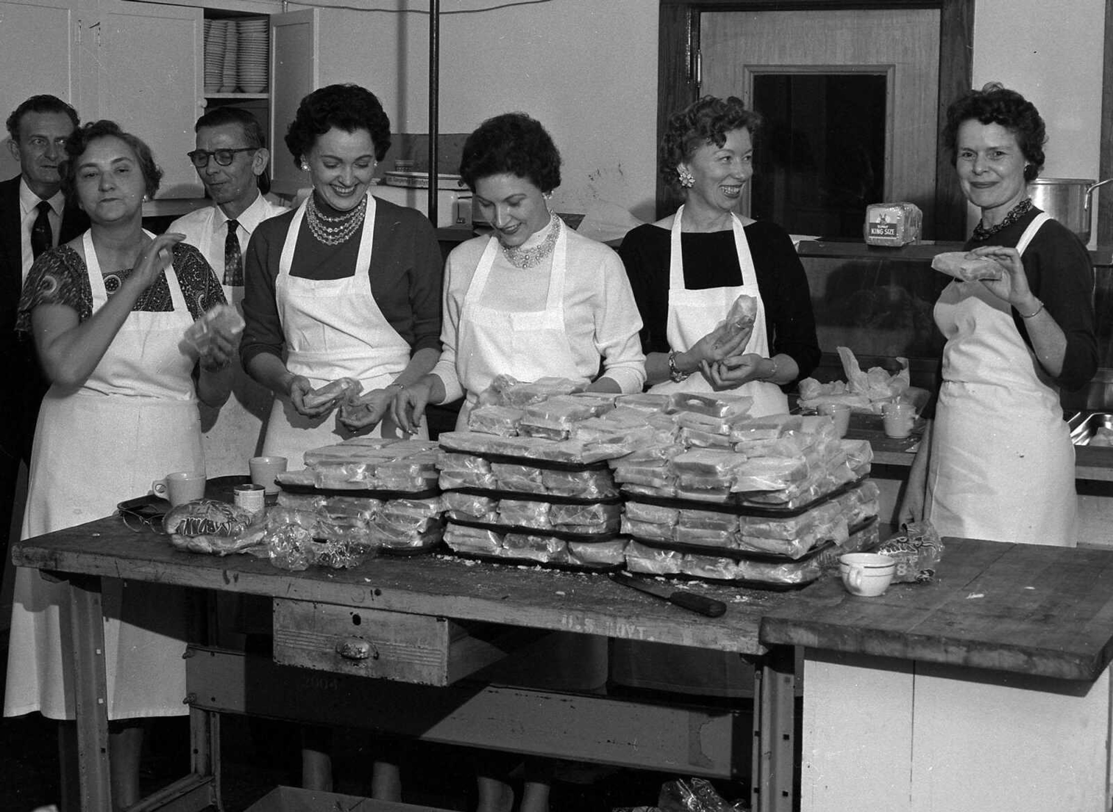 Feb. 25, 1961 Southeast Missourian.
The International Shoe Co. plant held social events for its employees with supervision by the Recreation Unit. This group prepared sandwiches, from left, Earl Burcham, Unit president; Mrs. Goldie Bahner, Dallas Robinson, Mrs. Peggy Fassel, Mrs. Doris Stevens, Miss Marie Hager and Mrs. Marie Clark. (G.D. Fronabarger/Southeast Missourian archive)

[Peggy Fassel said it was the food committee which made sandwiches for the International Shoe Company's Christmas party at the Arena Building in the early 1960s. Fassel is fourth from left. Next to her, in the light-colored top, is Dorris Stevens. The last two women on the right were from the Fitting Department.]