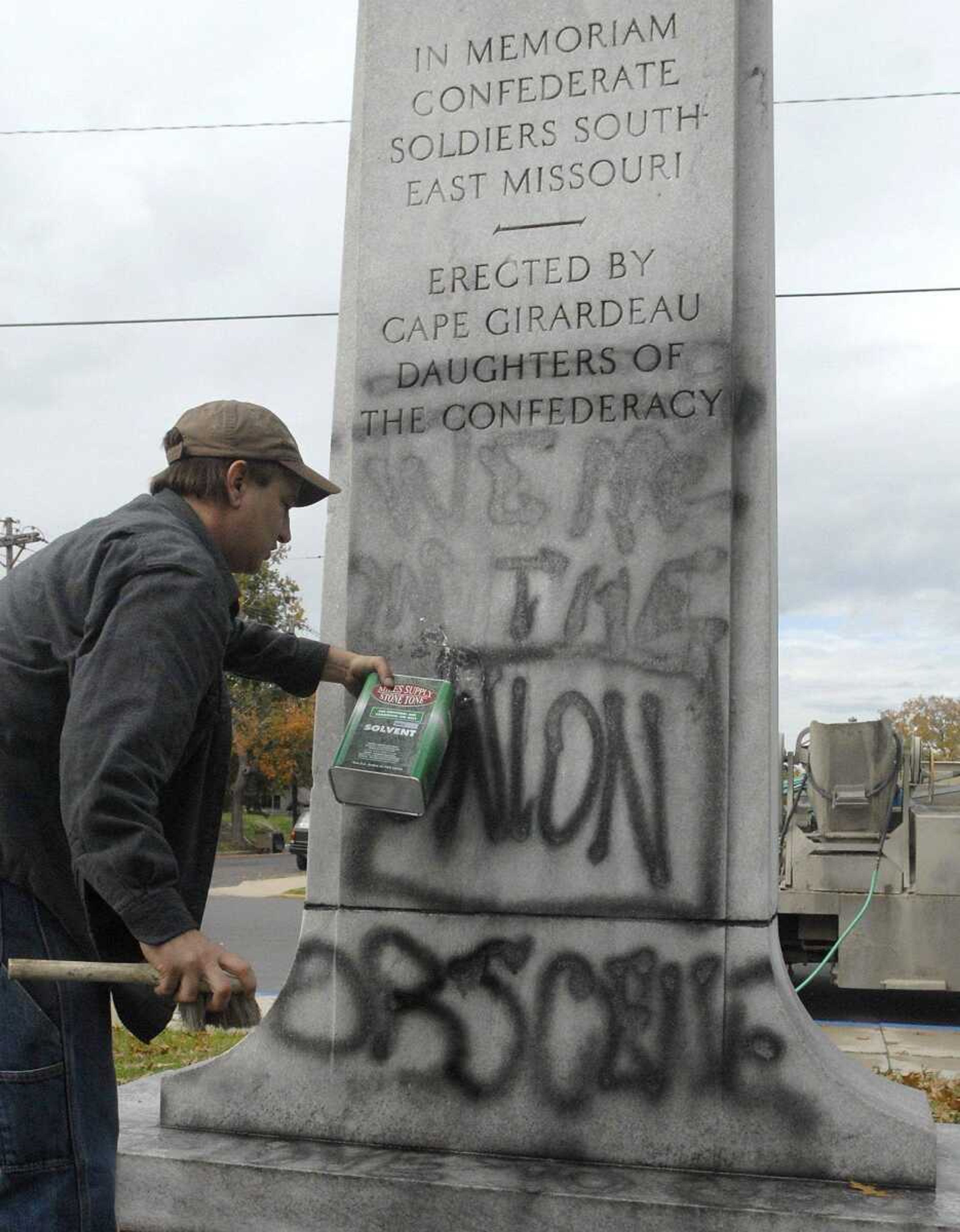 Jeff Abernathy with Liley Monument Works douses the graffiti on the Civil War monument in the courtyard of the Common Pleas Courthouse with industrial solvent Tuesday morning, October 11, 2011 in Cape Girardeau. The estimated cost of the removal of the graffiti will be between four and six hundred dollars. (Laura Simon)