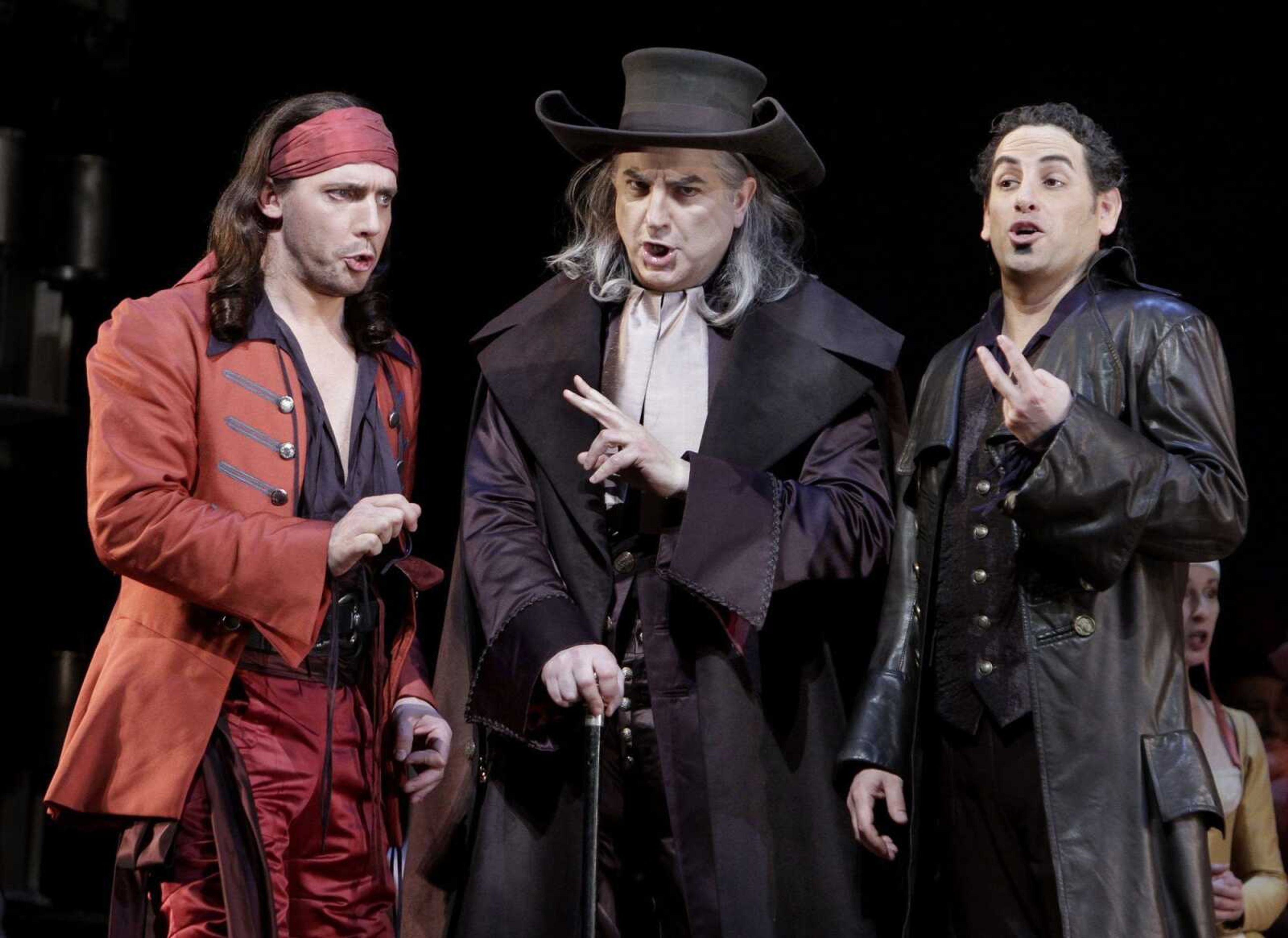 From left, Stephan Degout as Raimbaud, Michele Pertusi as The Tutor and Juan Diego Florez as Count Ory are shown during the final dress rehearsal of Rossini's "Le Comte Ory" at the Metropolitan Opera in New York's Lincoln Center. (AP Photo/Richard Drew)