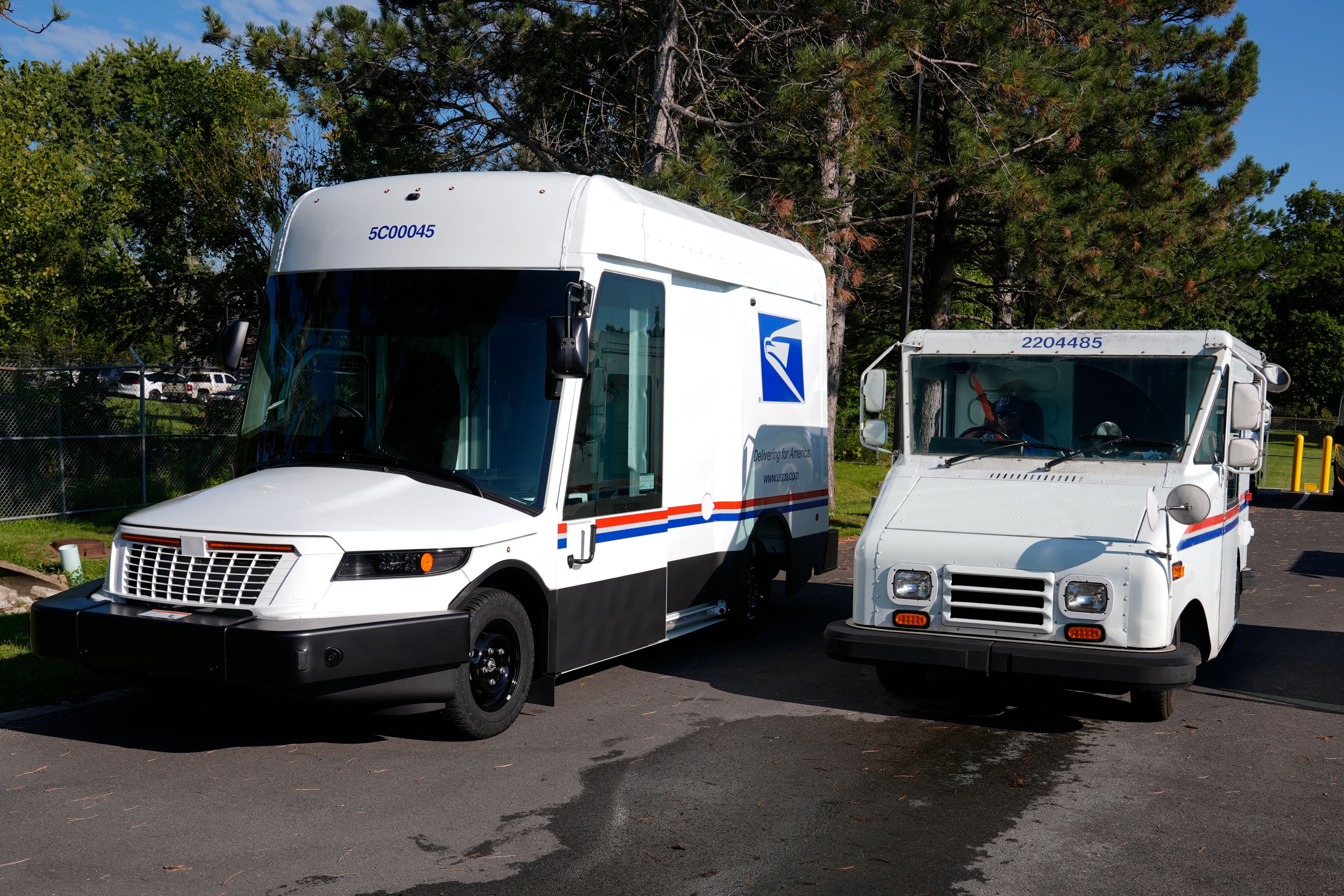 FILE - The U.S. Postal Service's next-generation delivery vehicle, left, is displayed as one of the current delivery trucks leaves the Kokomo Sorting and Delivery Center in Kokomo, Ind., Aug. 29, 2024. (AP Photo/Michael Conroy, File)