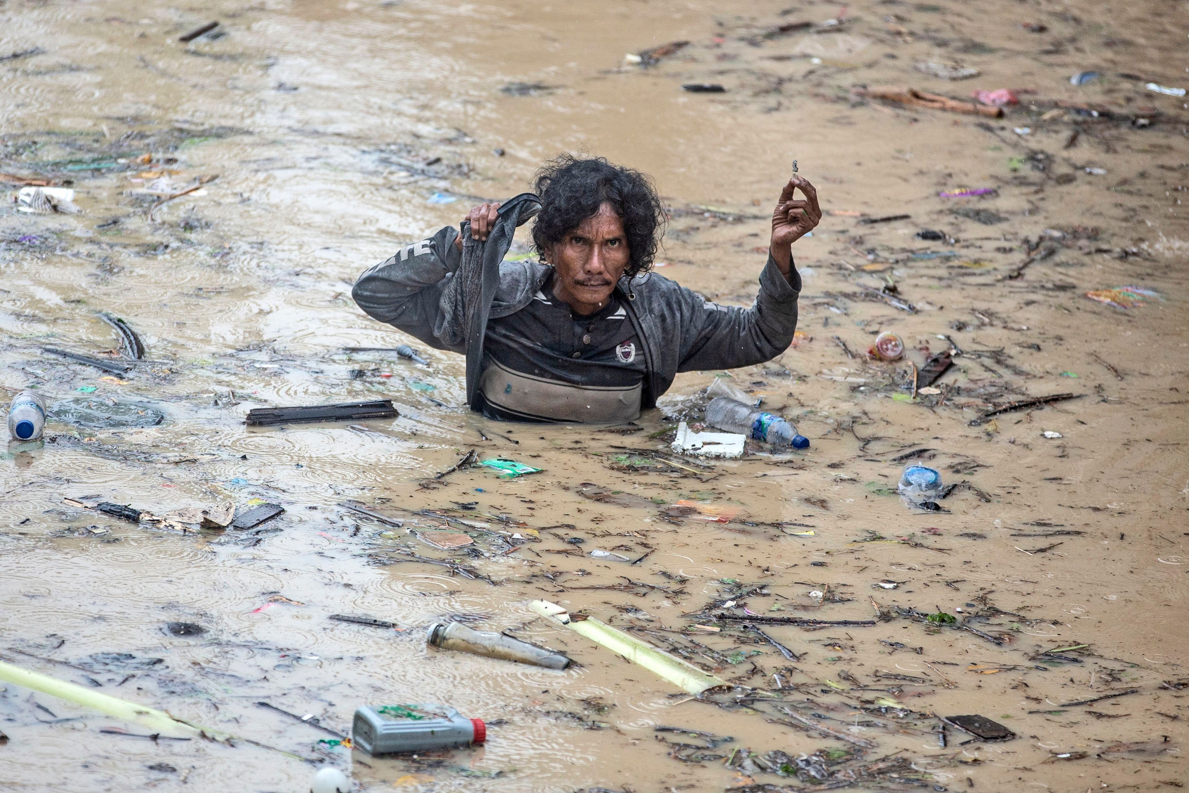 A man wades through flood water following heavy downpours in Medan, North Sumatra, Indonesia, Wednesday, Nov. 27, 2024. (AP Photo/Binsar Bakkara)