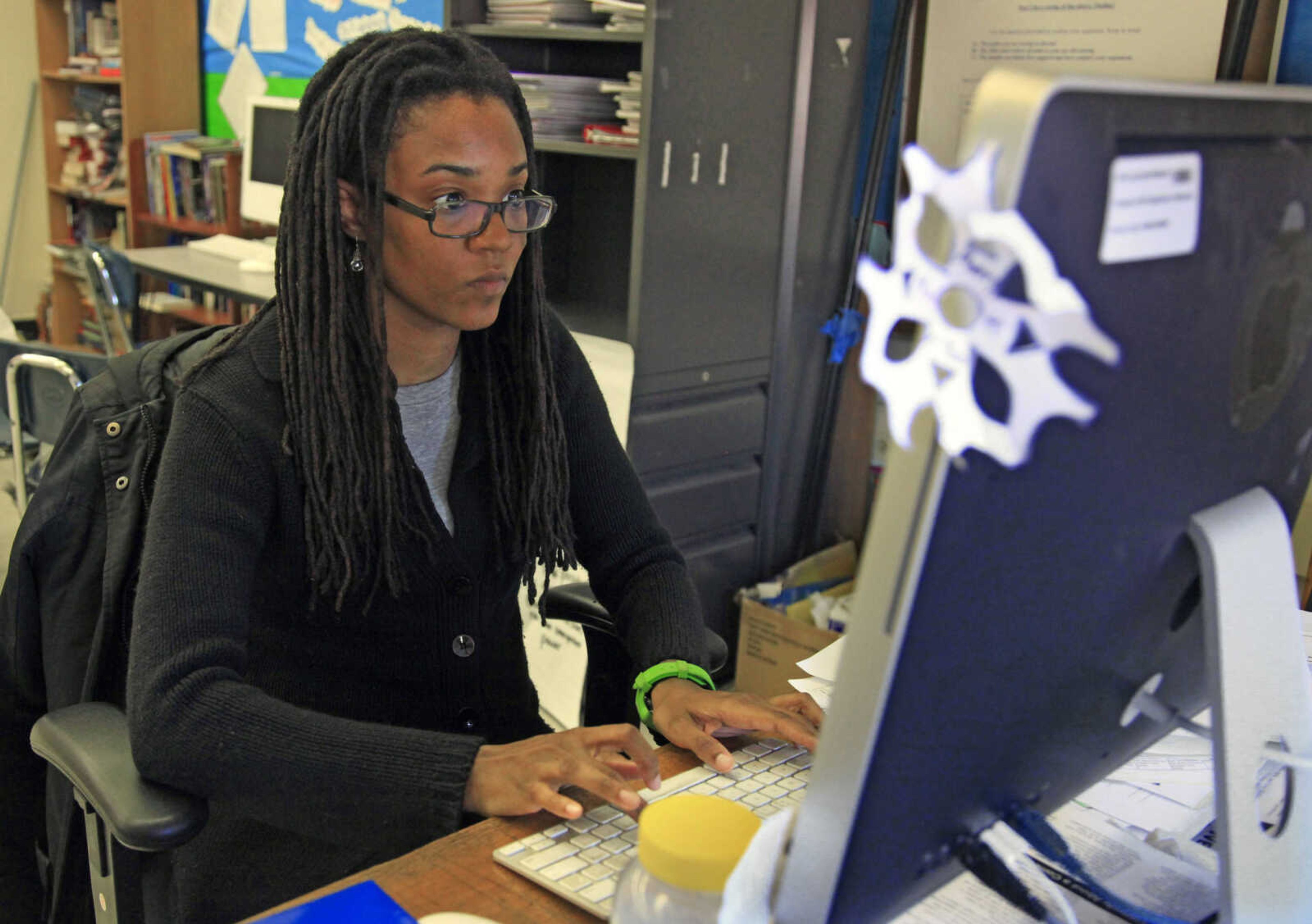 In this April 4, 2012 photo, Nkomo Morris, a teacher at Brooklyn's Art and Media High School, works on her classroom computer in New York. Morris, who teaches English and journalism, said she has about 50 current and former students as Facebook friends. That could be a problem if the new rules instruct teachers not to friend students.  (AP Photo/Bebeto Matthews)