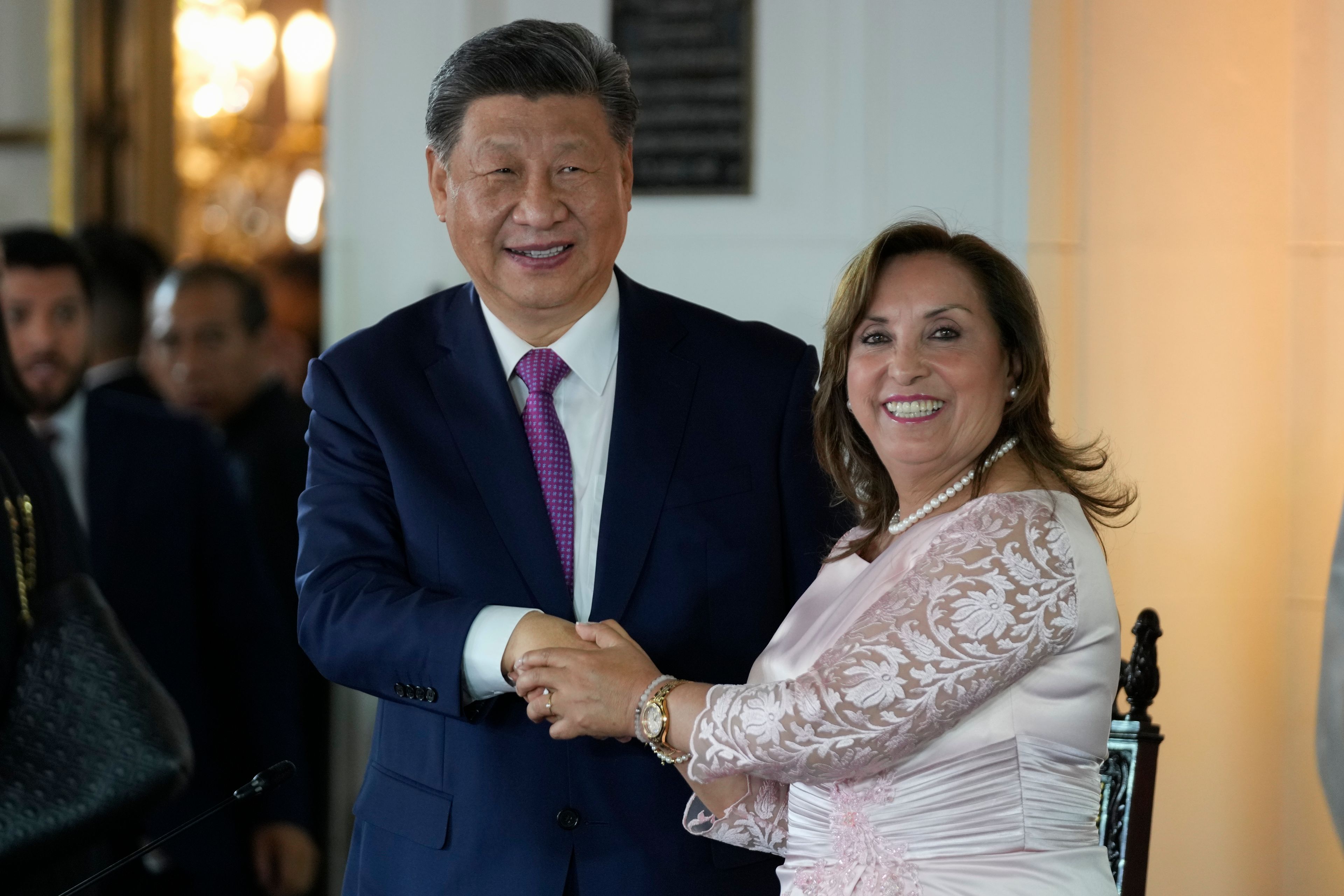 Peru's President Dina Boluarte, right, and Chinese President Xi Jinping shake hands after a ceremony to virtually inaugurate a Chinese-funded port in the city of Chancay, at the government palace in Lima, Peru, Thursday, Nov. 14, 2024. (AP Photo/Fernando Vergara)