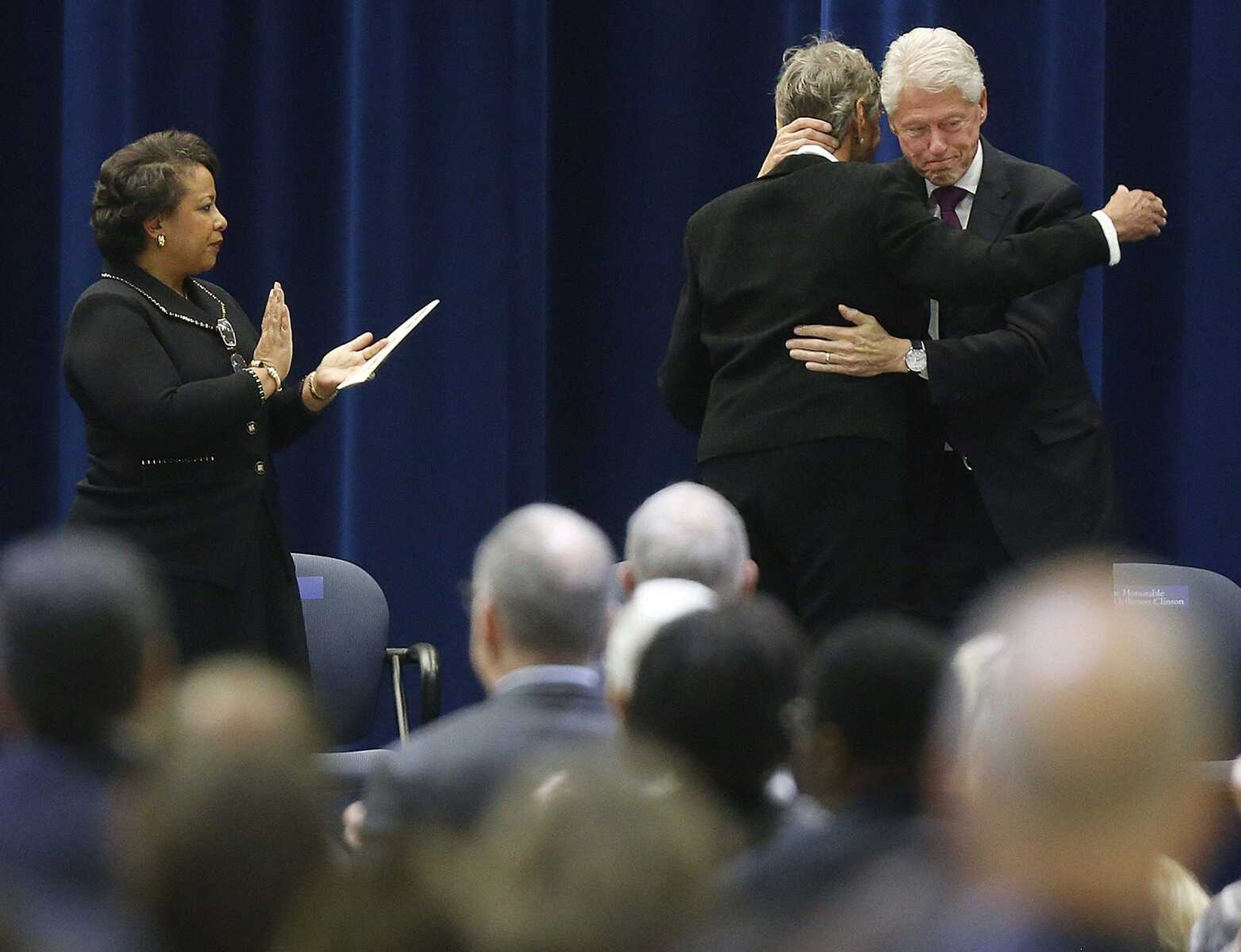 Maggy Reno Hurchalla, second from right, is embraced by former U.S. president Bill Clinton after giving the family remembrance as Attorney General Loretta Lynch, left, looks on at a public memorial service Sunday for former attorney general Janet Reno in Miami. Janet Reno died Nov. 7 at age 78 from complications from Parkinson's disease.