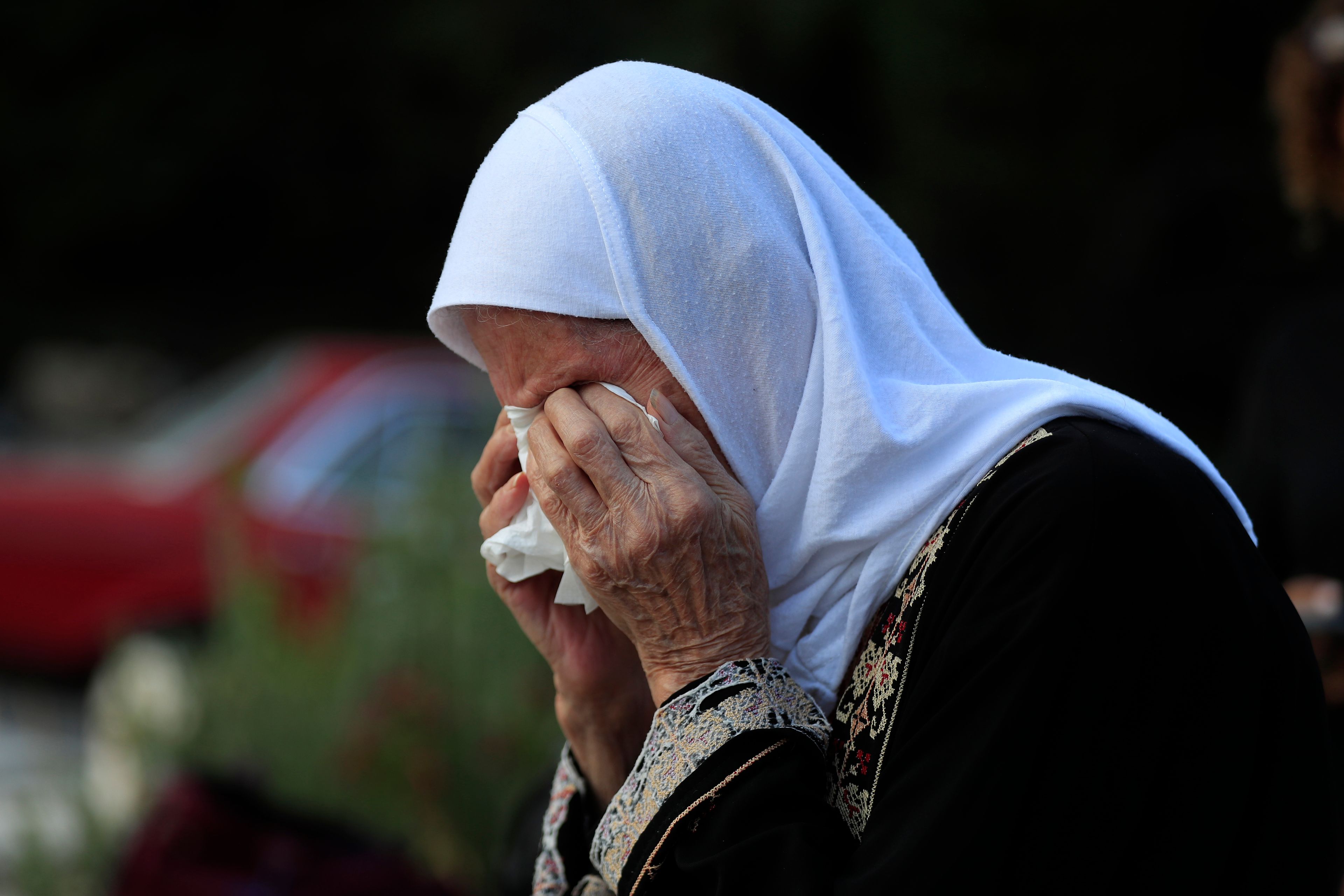 Jamileh Ramadan, cries as she visits the grave of her granddaughter Julia Ramadan, who was killed on Sept. 29 in Ain el Delb during the deadliest Israeli airstrike on a residential building during the first week of escalation between Israel and Hezbollah where more than 70 people were killed, in the southern port city of Sidon, Lebanon, Thursday, Oct. 10, 2024.(AP Photo/Mohammed Zaatari)