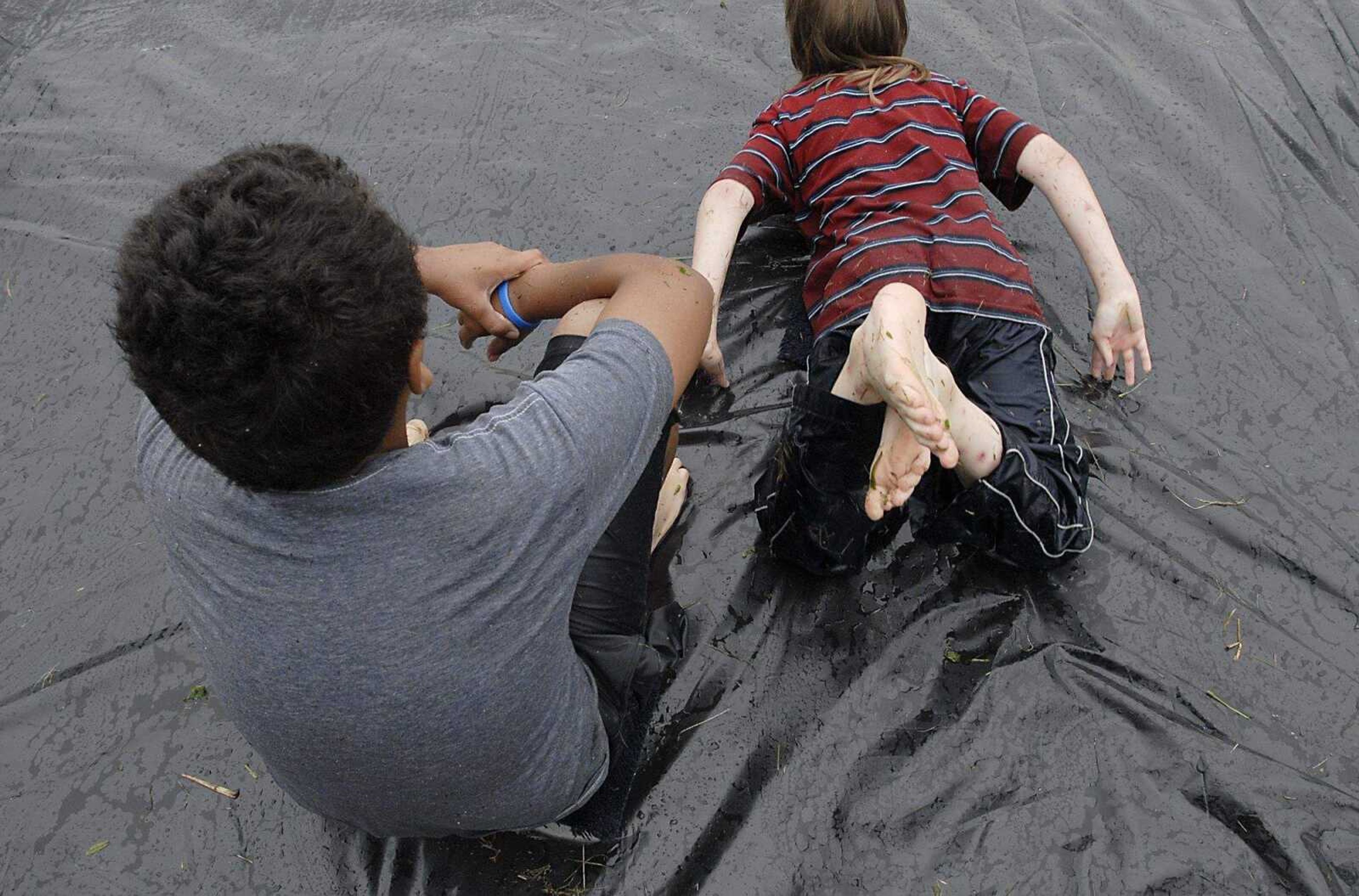 KIT DOYLE ~ kdoyle@semissourian.com
Pushing off for another slide down the tarp at Pellegrino Park in Marble Hill.