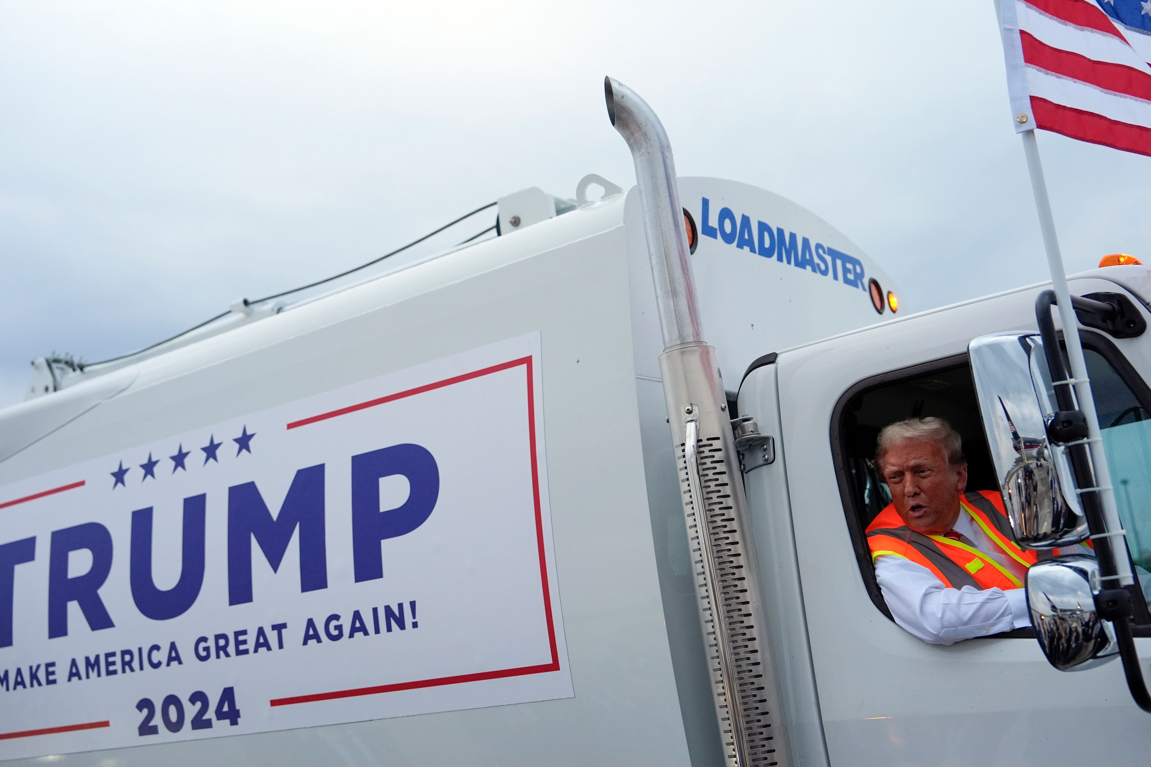 Republican presidential nominee former President Donald Trump talks to reporters as he sits in a garbage truck Wednesday, Oct. 30, 2024, in Green Bay, Wis. (AP Photo/Julia Demaree Nikhinson)