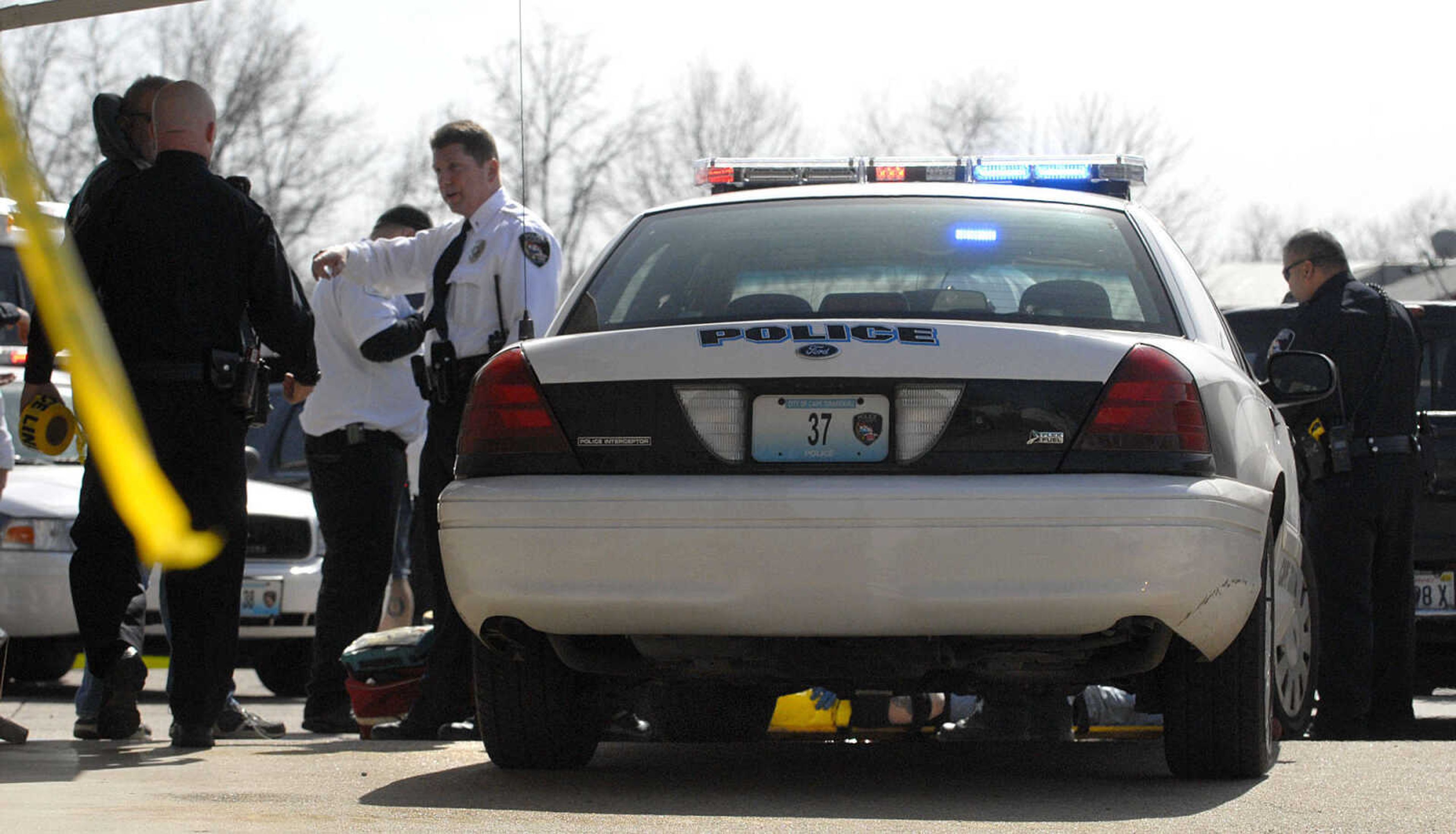 LAURA SIMON ~ lsimon@semissourian.com
Cape Girardeau emergency responders work the scene of a victim of a self-inflicted gun shot wound outside Dan's Key and Lock Tuesday afternoon, March 6, 2012. Police say the man is a suspect in a Sunday assault along Cape LaCroix Recreational Trail.