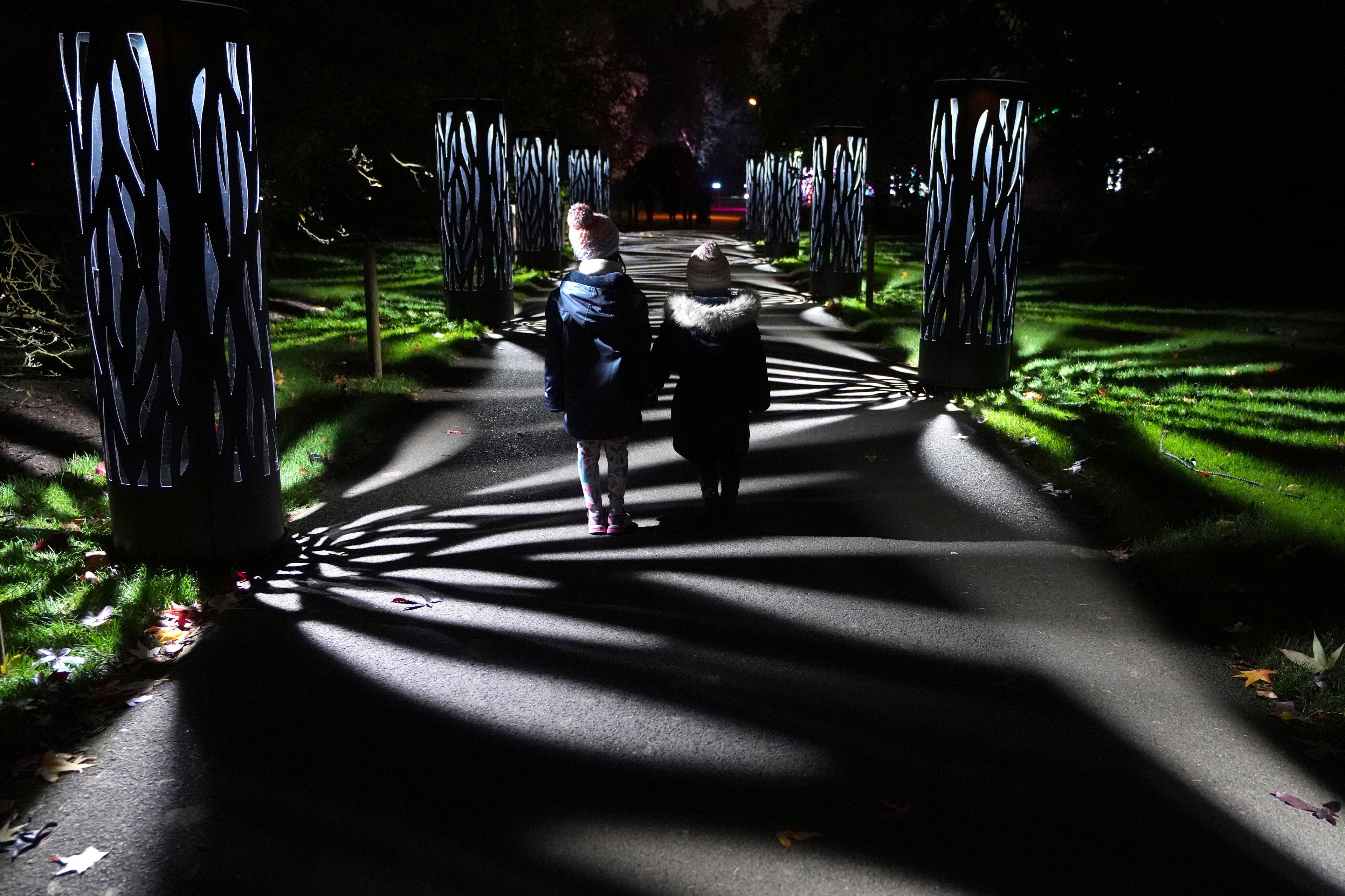 Children view the Christmas light trail as it returns for its12th year with new installations set within the UNESCO World Heritage Site landscape of Kew Gardens in London, England, Tuesday, Nov. 12, 2024. (AP Photo/Kirsty Wigglesworth)