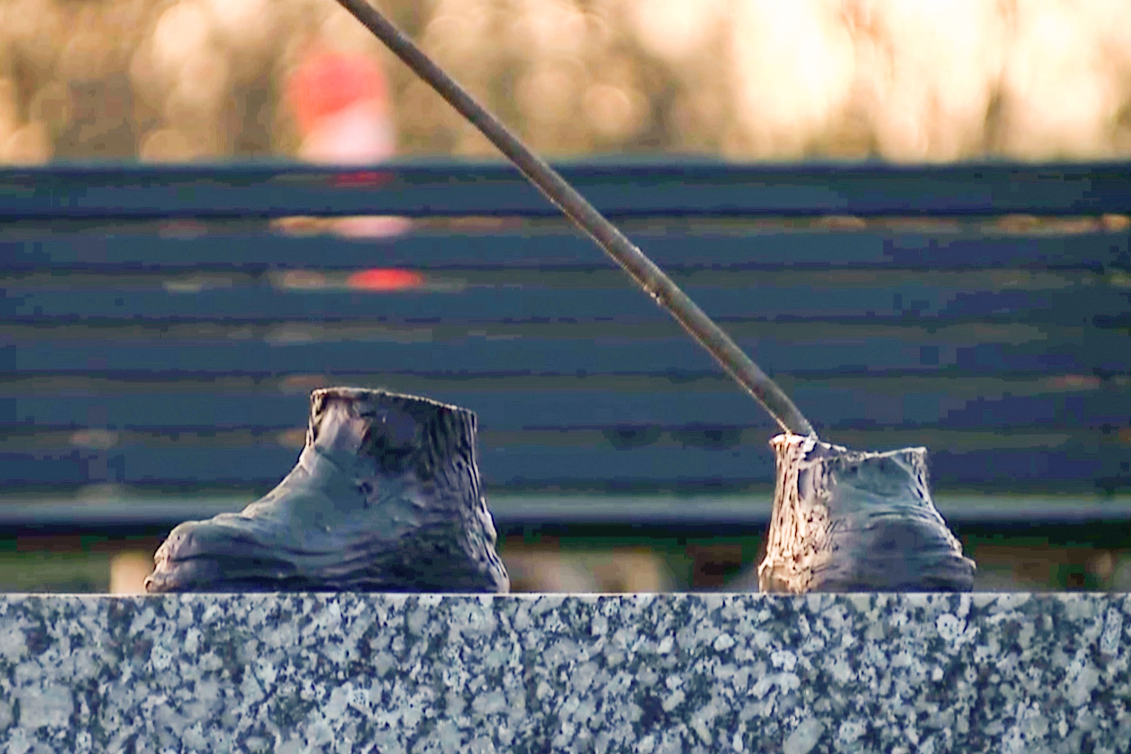 In this image taken from a video provided by WXYZ, only the feet are left of a 600-pound bronze statue of a Tuskegee airman after it was stolen from a city park in Detroit on Friday, October 24, 2024. (WXYZ via AP)