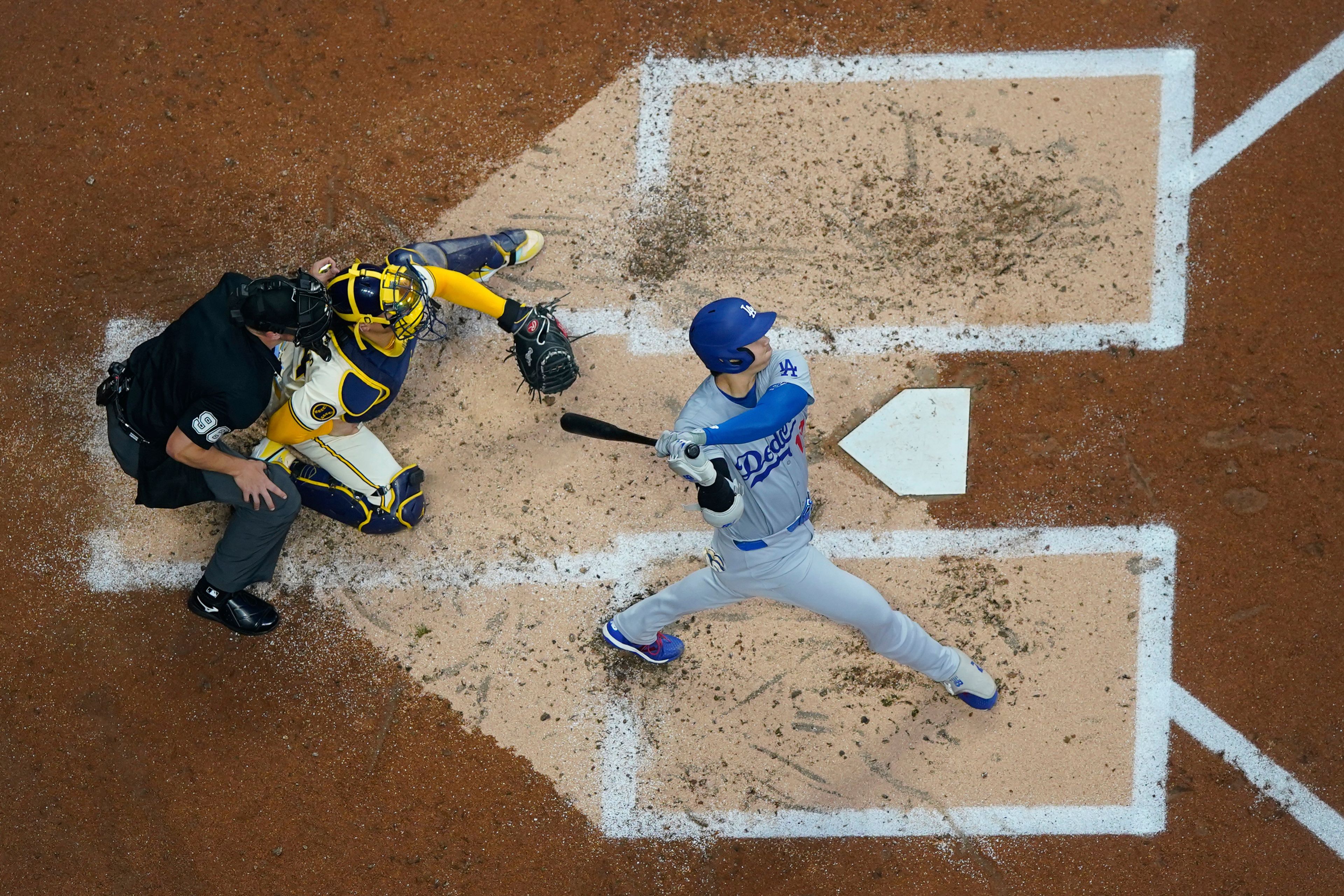 Los Angeles Dodgers' Shohei Ohtani hits a solo home run during the third inning of a baseball game against the Milwaukee Brewers, Tuesday, Aug. 13, 2024, in Milwaukee. (AP Photo/Aaron Gash)