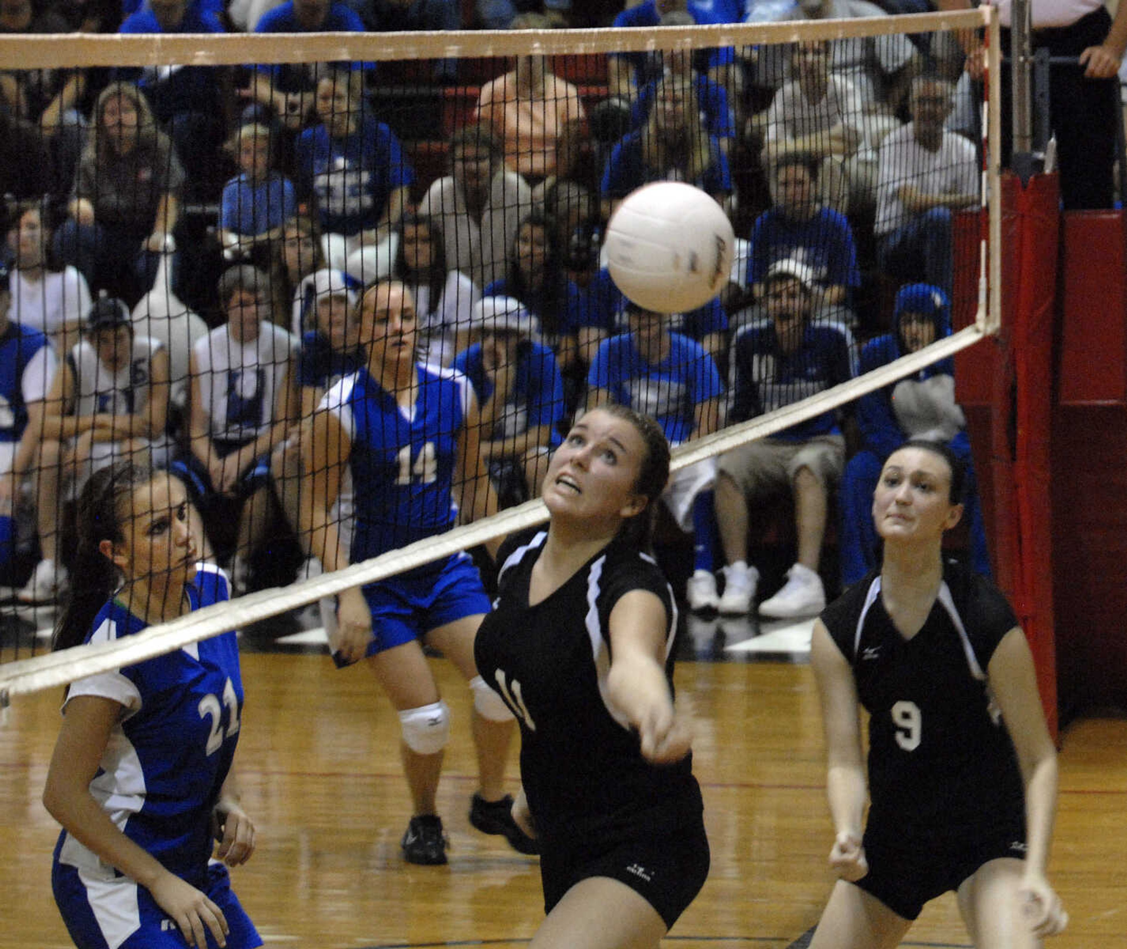 FRED LYNCH ~ flynch@semissourian.com
Bell City's LaGena Strobel tries to keep the ball in play with teammate Alex Eakin as Leopold's Lauren Seiler, left, and Mallory James look on during the third game Friday at Bell City.