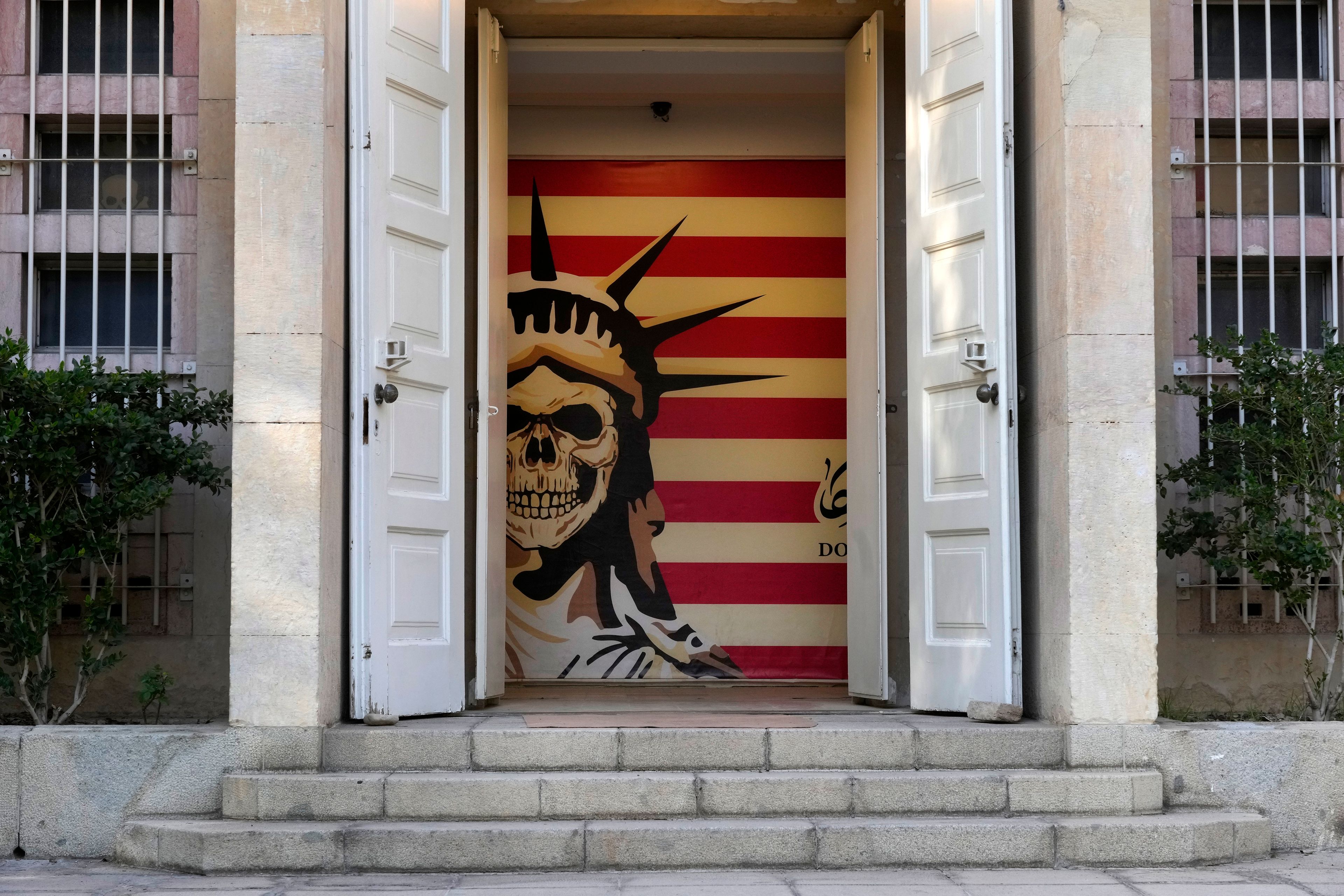 The entrance to the former U.S. Embassy, which has been turned into an anti-American museum, is seen with a satirised image of the Statue of Liberty and the U.S. flag in Tehran, Iran, Tuesday, Oct. 22, 2024. (AP Photo/Vahid Salemi)