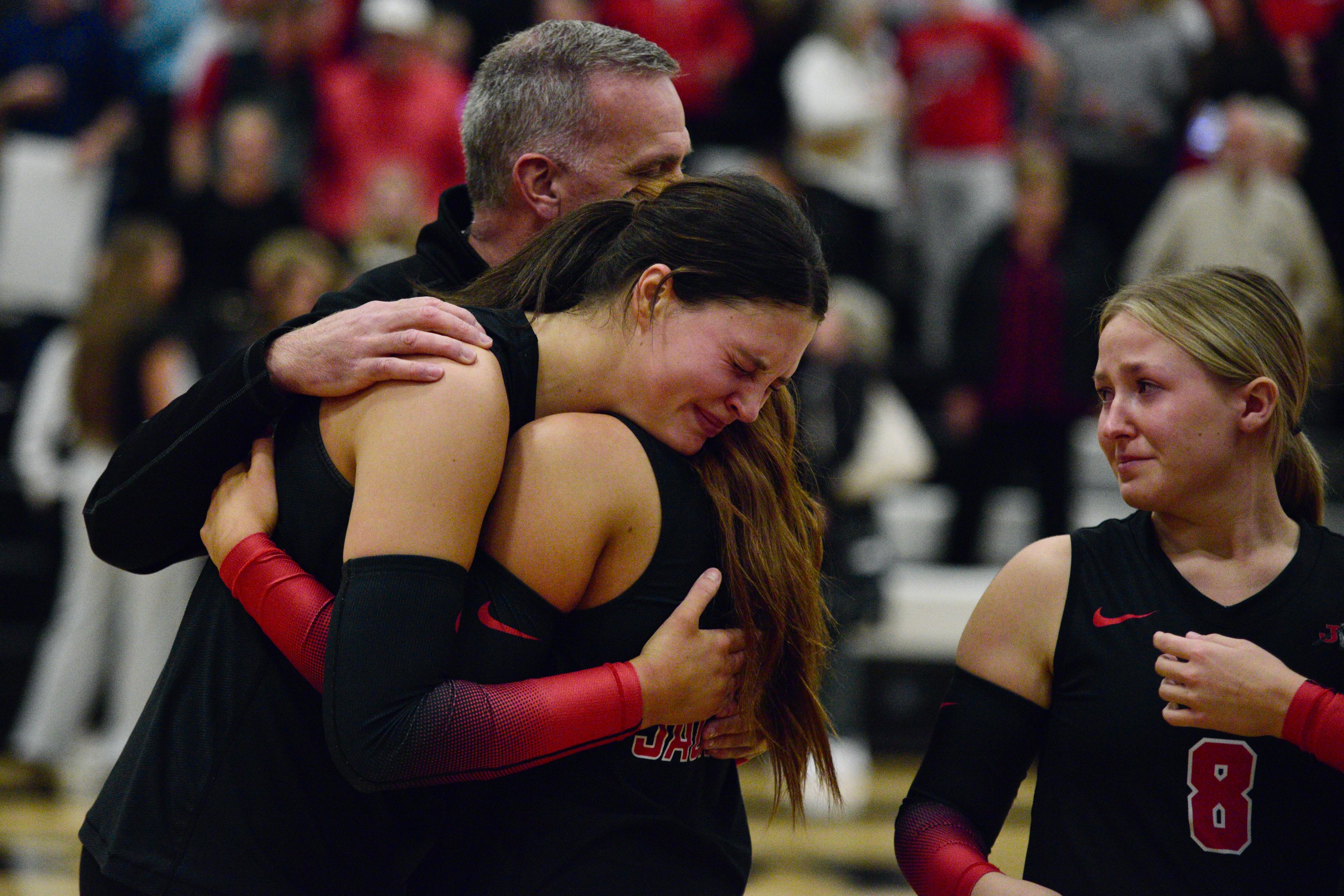 Jackson volleyball coach Dave Mirly consoles Kathie St. John, who hugs a teammate after the Indians lose to Lafayette in the Class 5 quarterfinals on Saturday, Nov. 2, in Wildwood. 