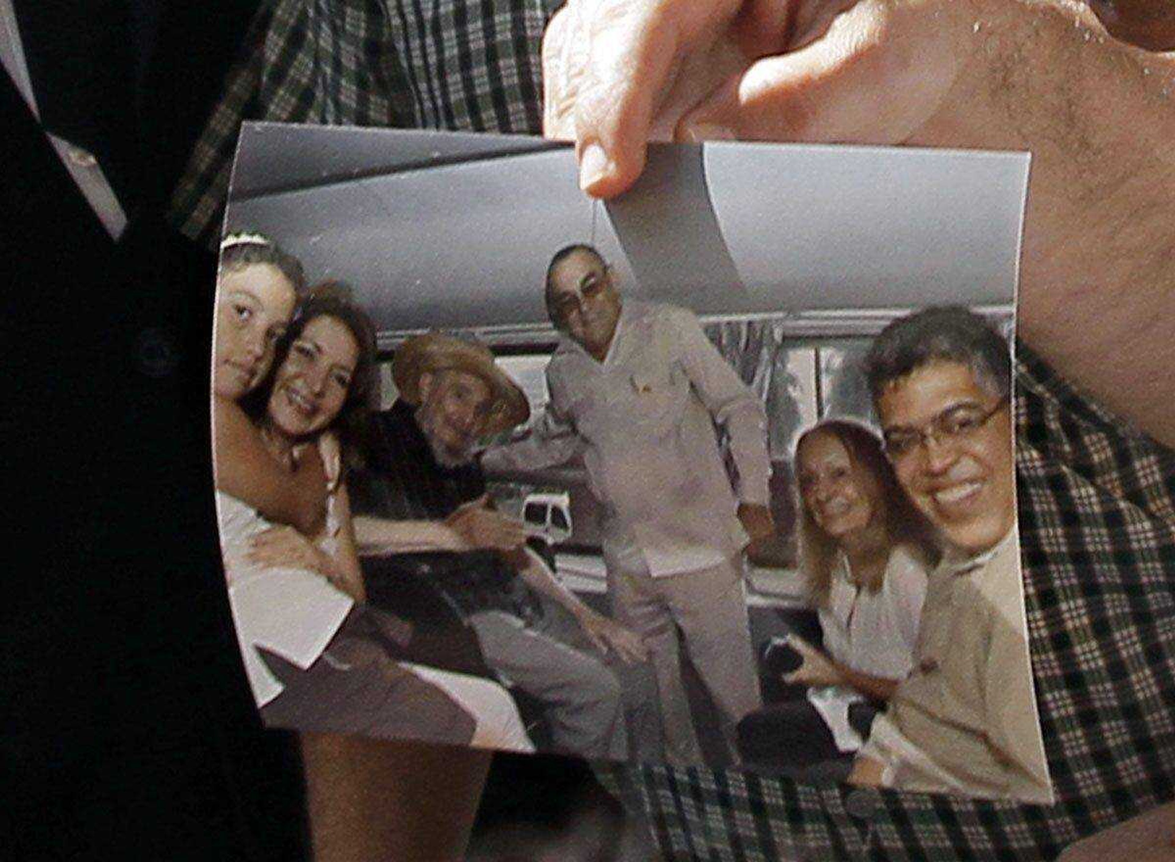 Former Venezuelan vice president Elias Jaua shows a picture of Cuba&#8217;s leader Fidel Castro, third from left, at the Hotel Nacional in Havana on Sunday. (Franklin Reyes ~ Associated Press)