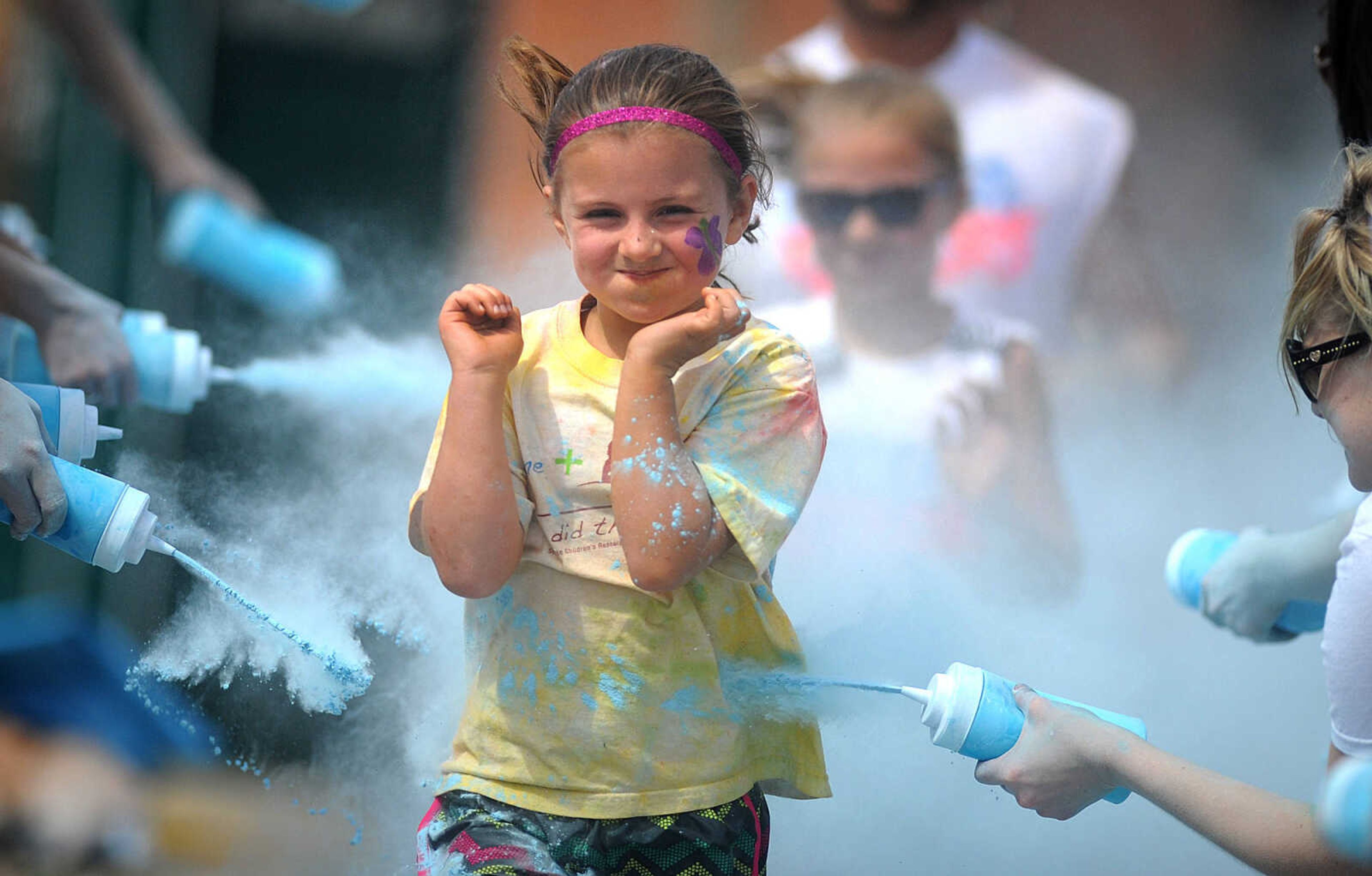 LAURA SIMON ~ lsimon@semissourian.com

Participants in the Color Me Cape 5K are sprayed with blue powder at the final color station on Main Street, Saturday, April 12, 2014, in Cape Girardeau.