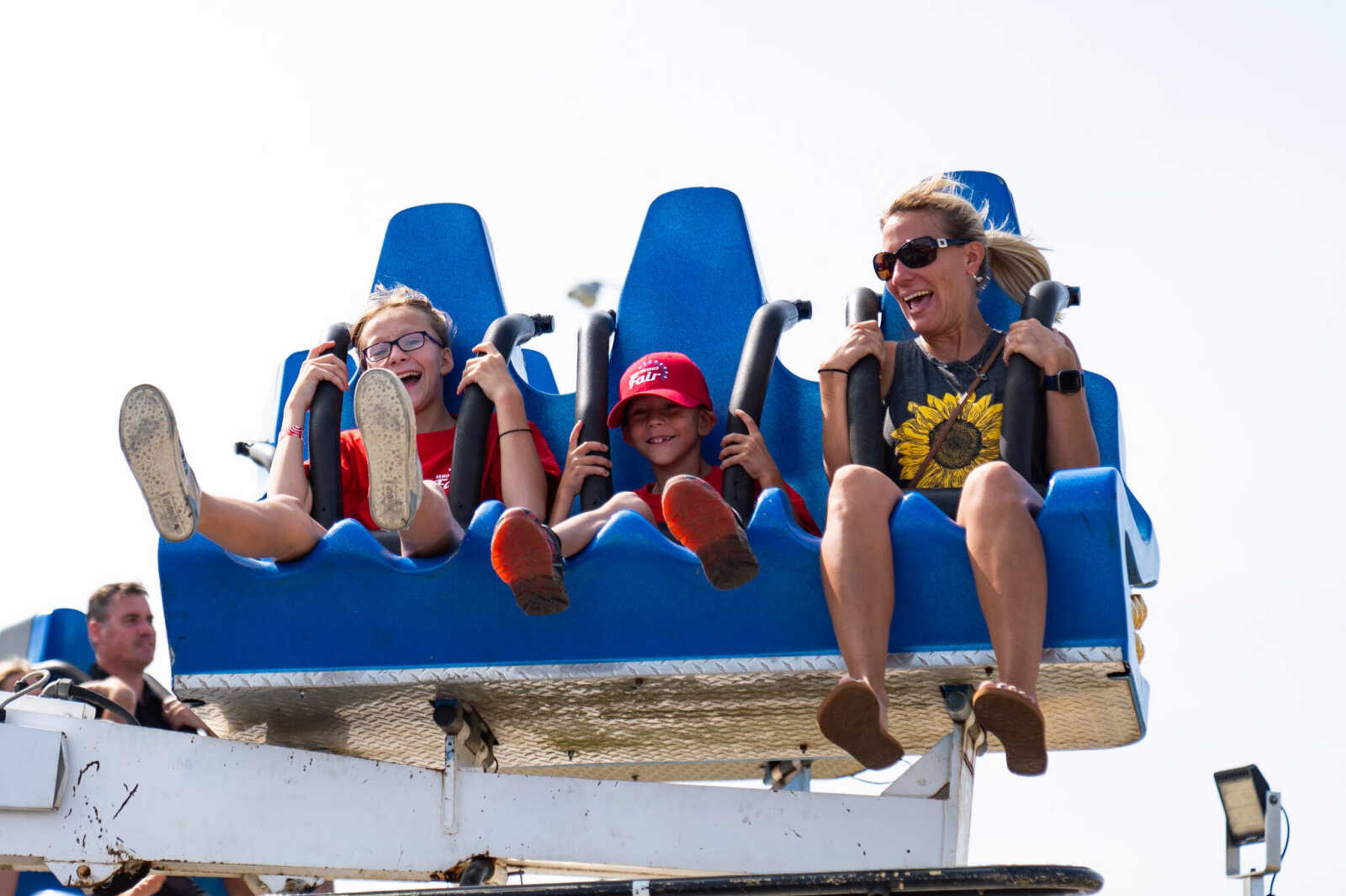 From left, Lynlie Gerecke, Heston Gerecke and Leah Henley enjoy one of the fair rides.