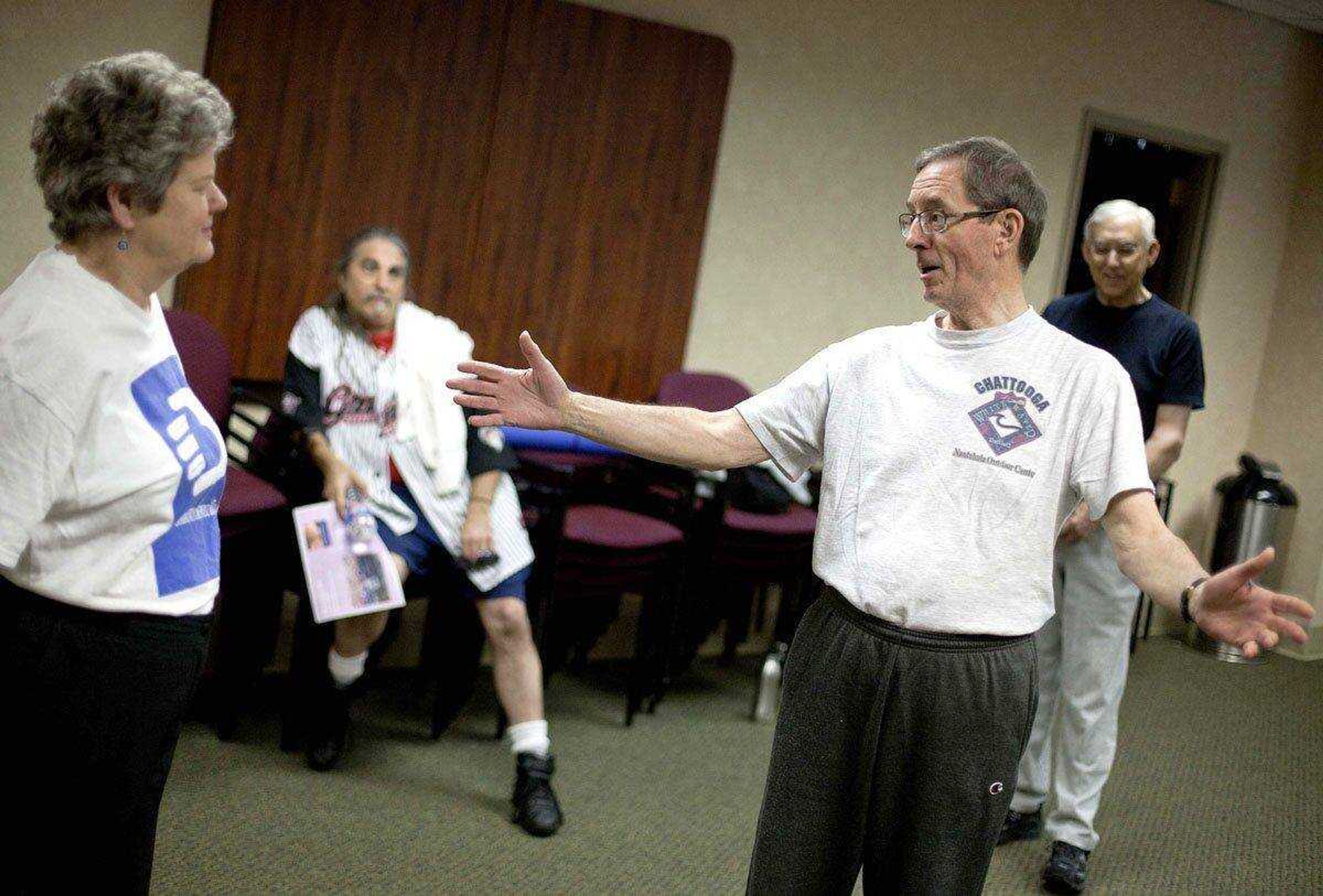 In a Wednesday, April 25, 2012 photo, cancer survivor Lawrence Gentner, 68, of Snellville, Ga., talks with his exercise group after a class, in Atlanta. A cancer diagnosis often inspires people to exercise and eat healthier. Now the experts say there's evidence that that may help the disease from returning. The American Cancer Society on Thursday issued new guidelines urging doctors to talk to their cancer patients about slimming down if they're fat, eating right and doing some exercise. (AP Photo/David Goldman)