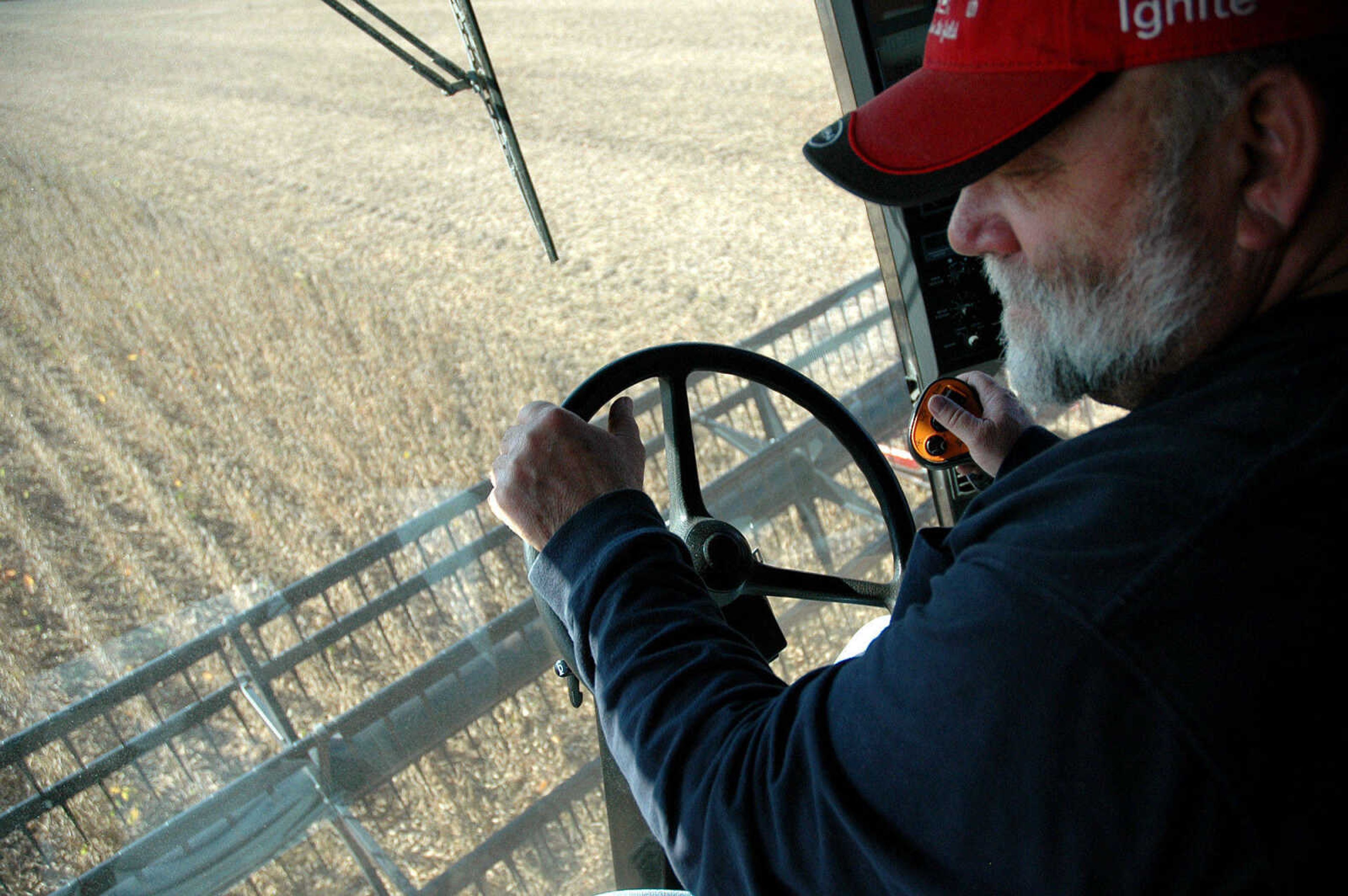 MELISSA MILLER ~ mmiller@semissourian.com
Steve Wright harvests soybeans near Wyatt, Mo., in fields covered with
floodwaters after the intentional breach of the Birds Point Levee.
It took about two months for the waters to receded and although soybeans
were planted one to two months later than usual, the harvest season is now
going smoothly in the floodway area. Yields so far appear to be lower than
last year.