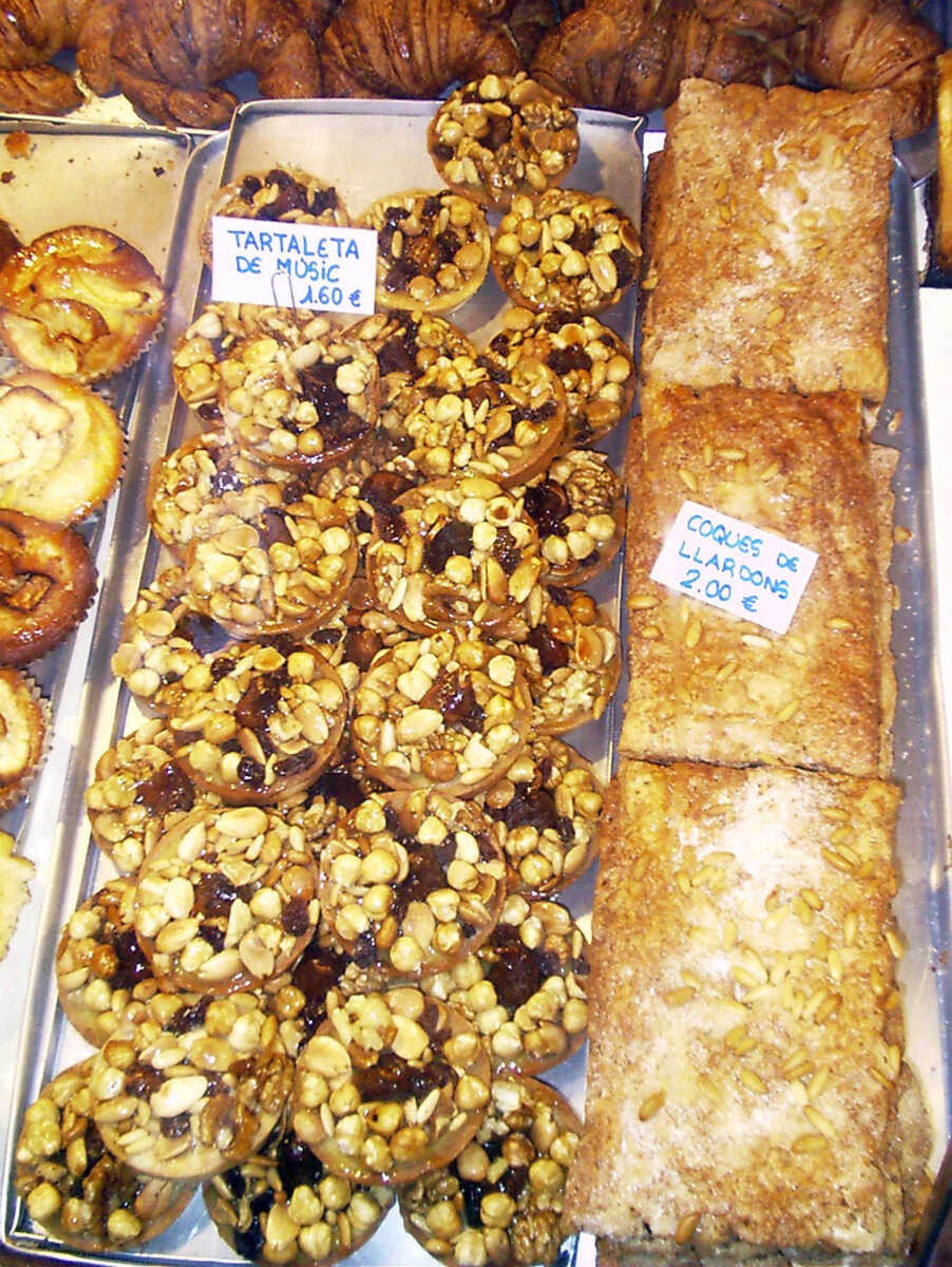 An array of Spanish pastries tempt people on the streets of Barcelona.