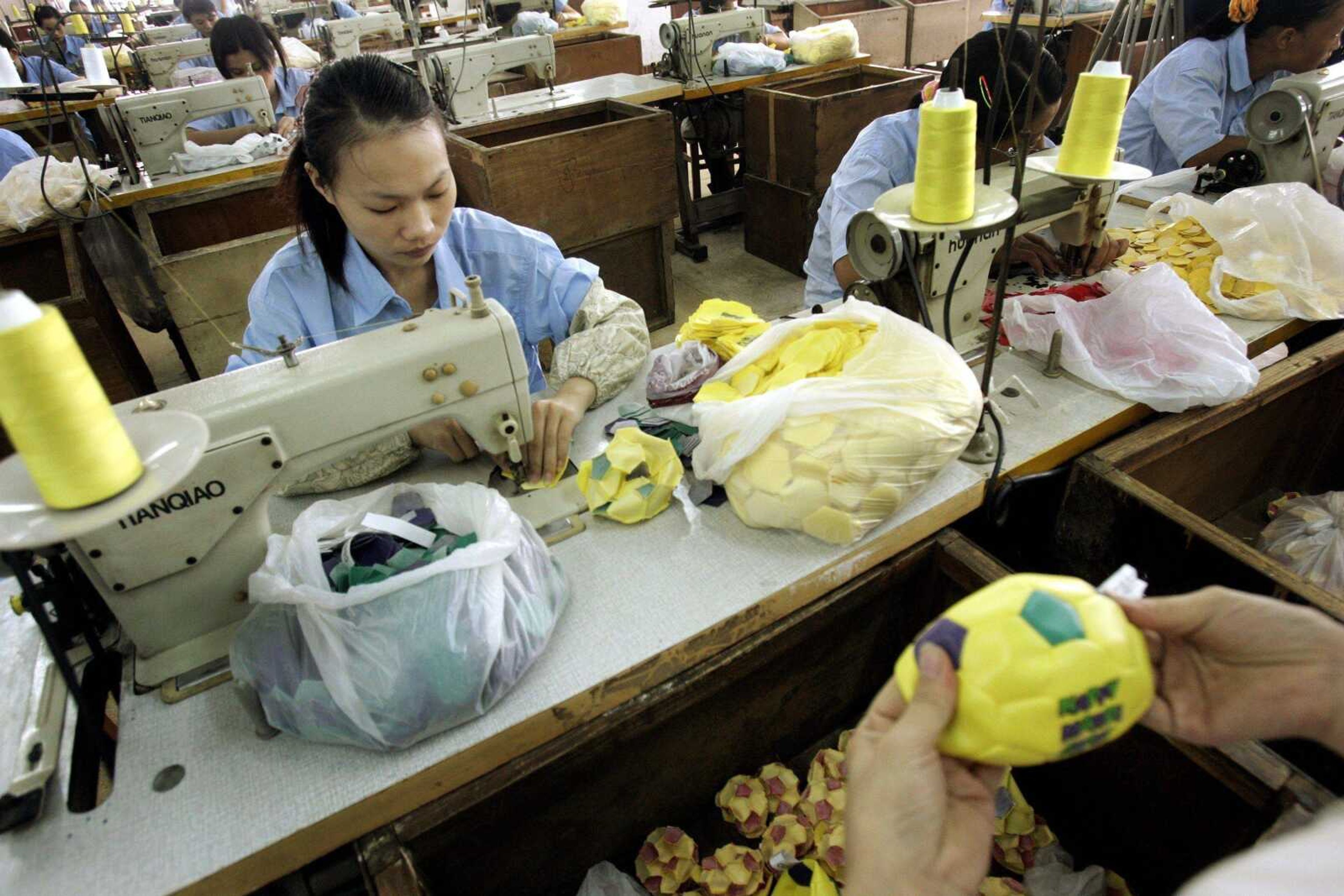 Workers assembled small soccer balls on the production line at Ball Star Toys Co. Ltd. in Guangzhou, China. (Eugene Hoshiko ~ Associated Press)