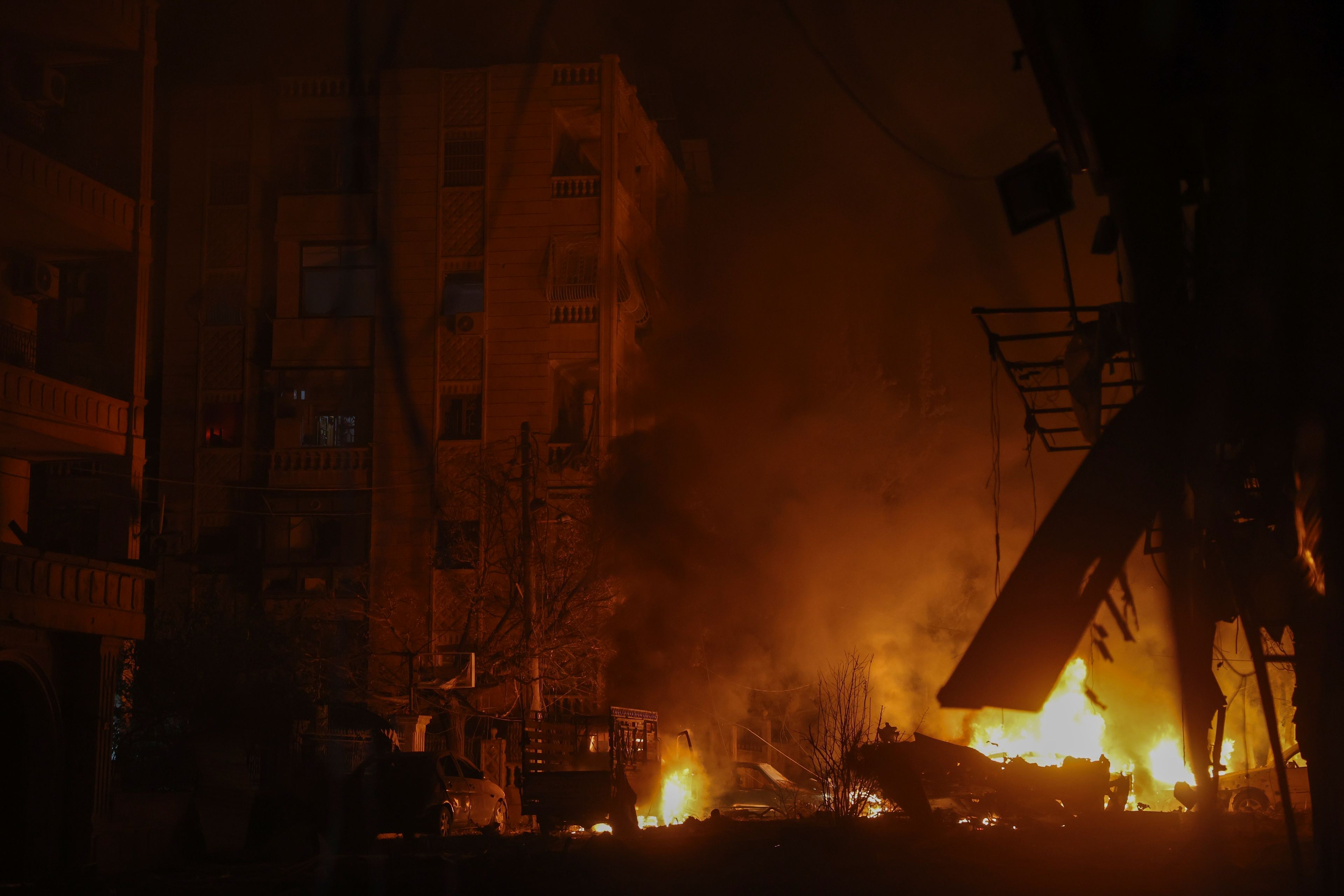 Vehicles burn after an airstrike against opposition fighters in Aleppo, Syria, late Friday, Nov. 29, 2024. (AP Photo/Ghaith Alsayed)