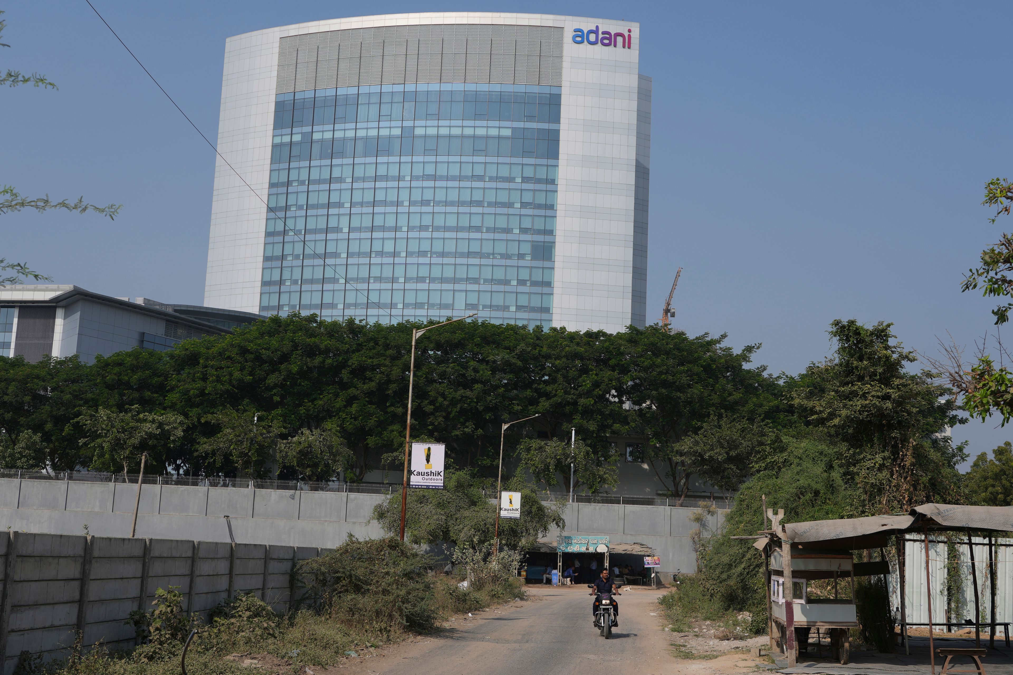 A motorcyclist ride past the Adani's corporate house in Ahmedabad, India, Thursday, Nov. 21, 2024. (AP Photo/Ajit Solanki)