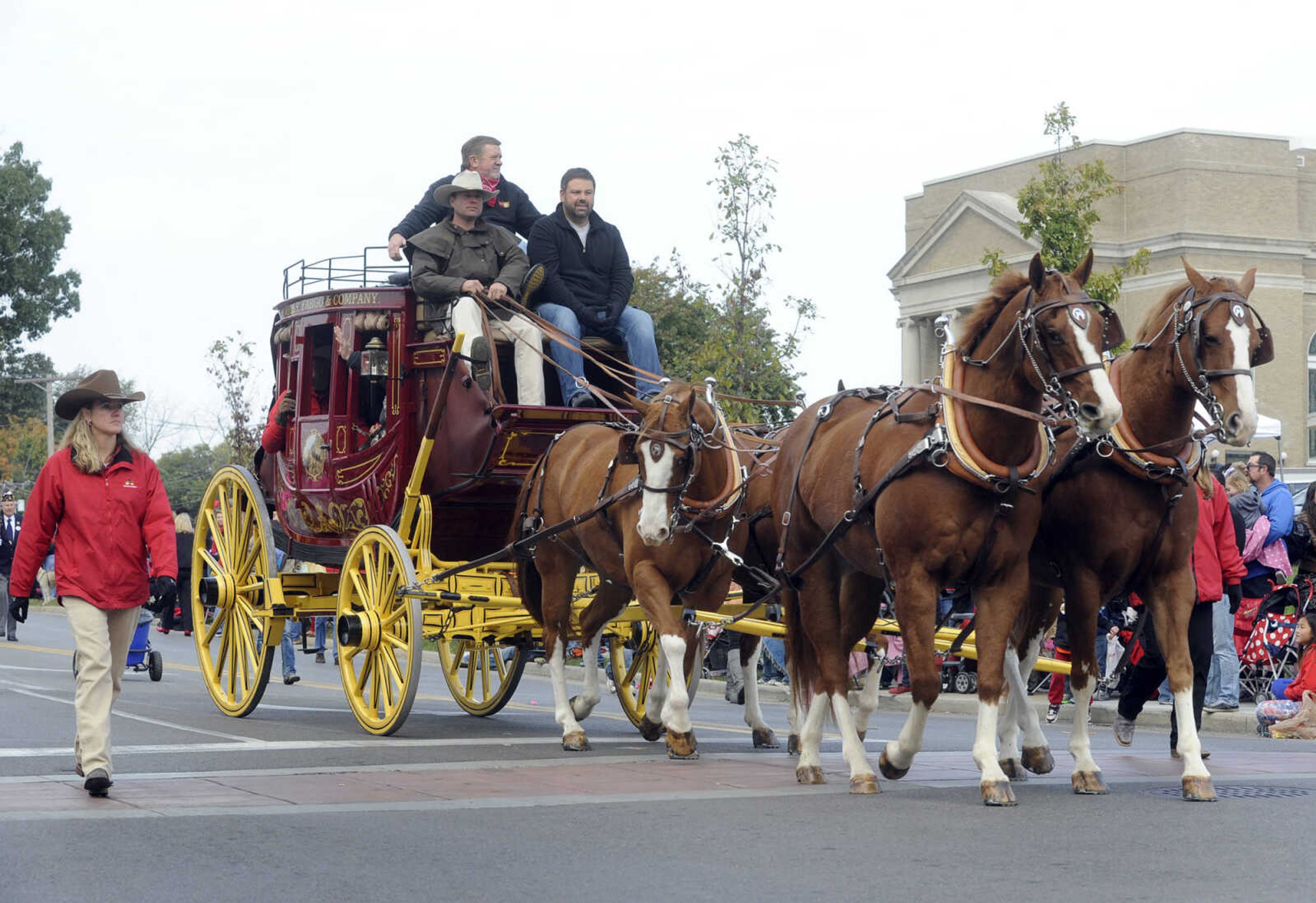 Horses pull a Wells Fargo & Company stagecoach in the SEMO Homecoming parade Saturday, Oct. 26, 2013 on Broadway in Cape Girardeau.