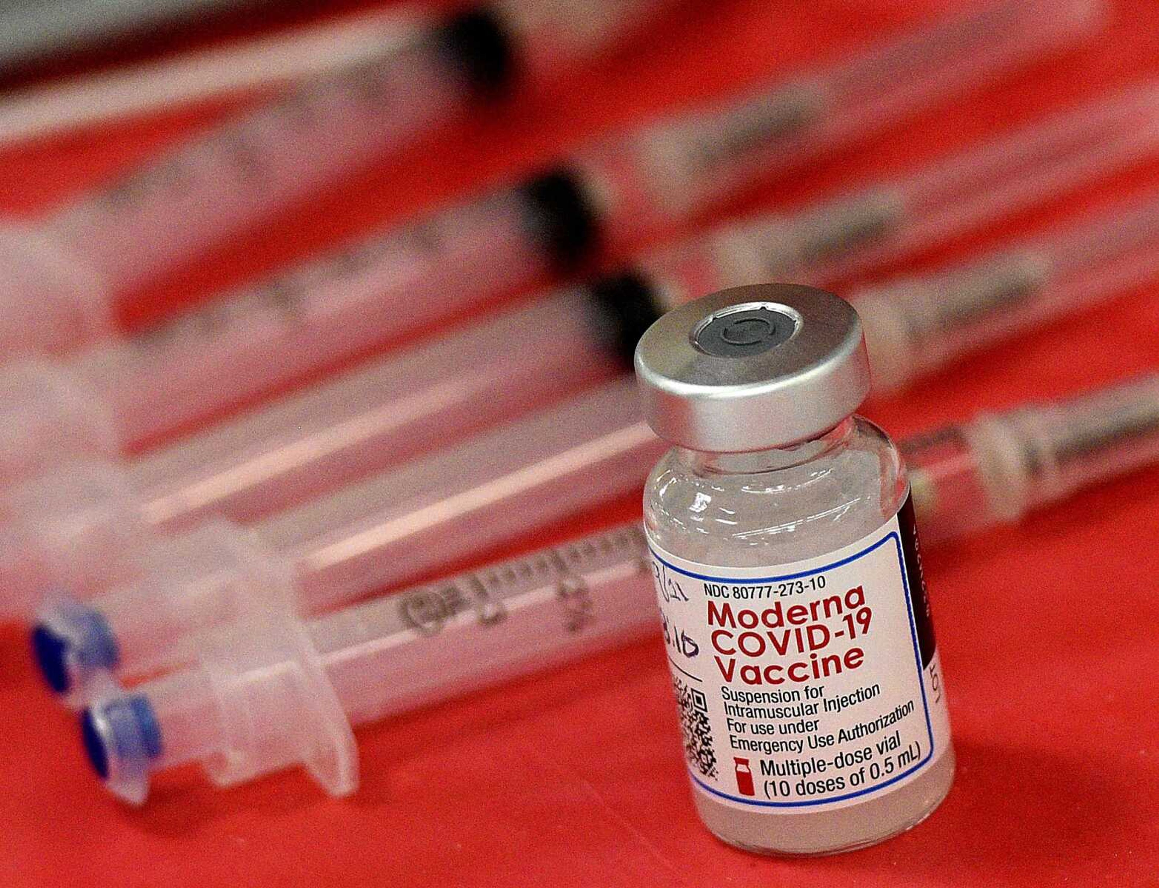 Syringes and a vial of the Moderna COVID-19 vaccine are displayed at a mass COVID-19 vaccination site March 19, 2021, in Batavia, Illinois. Moderna hopes to offer updated COVID-19 boosters in the fall combining its original vaccine with protection against the omicron variant.