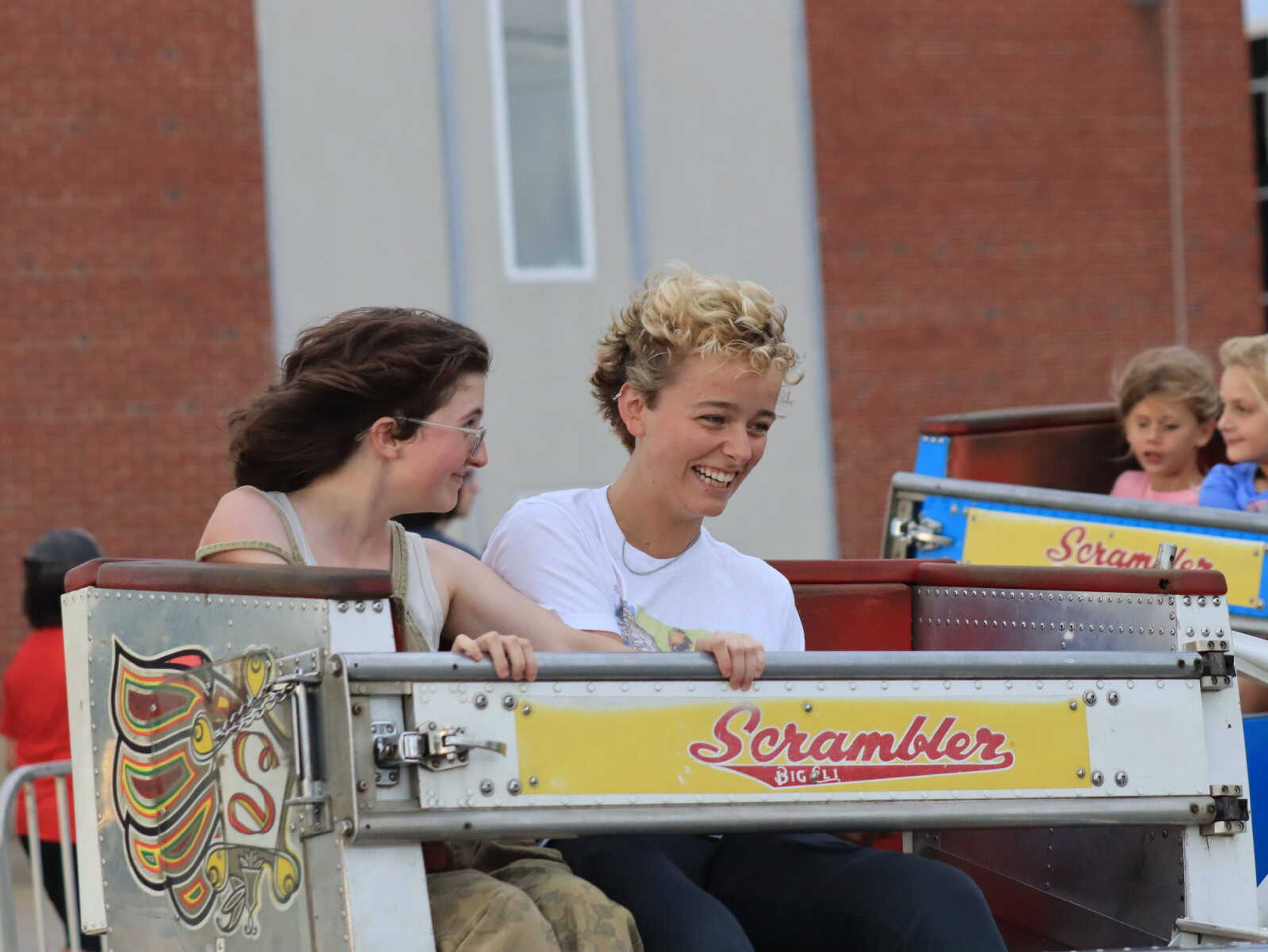 (Left) Alex Gilmore and &nbsp;Delaynie Spies on the Super Scrambler while it twirls them around and around at Jackson Homecomers.