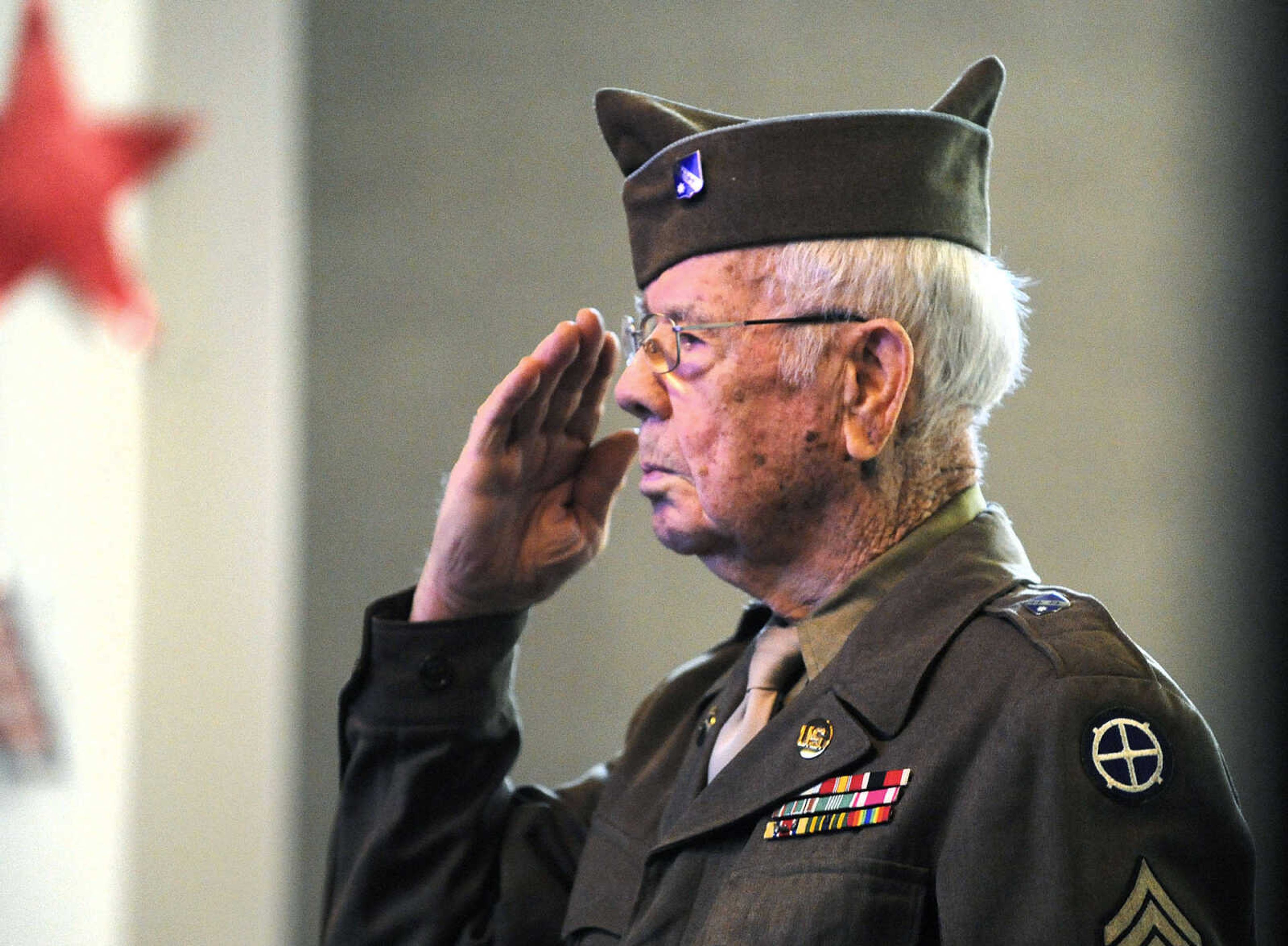 LAURA SIMON ~ lsimon@semissourian.com

Floyd Smith salutes after presenting flowers in remembrance of one of the lost crew members of the Flying Fortress 812 during WWII on Monday, March 21, 2016, at Alma Schrader Elementary in Cape Girardeau.