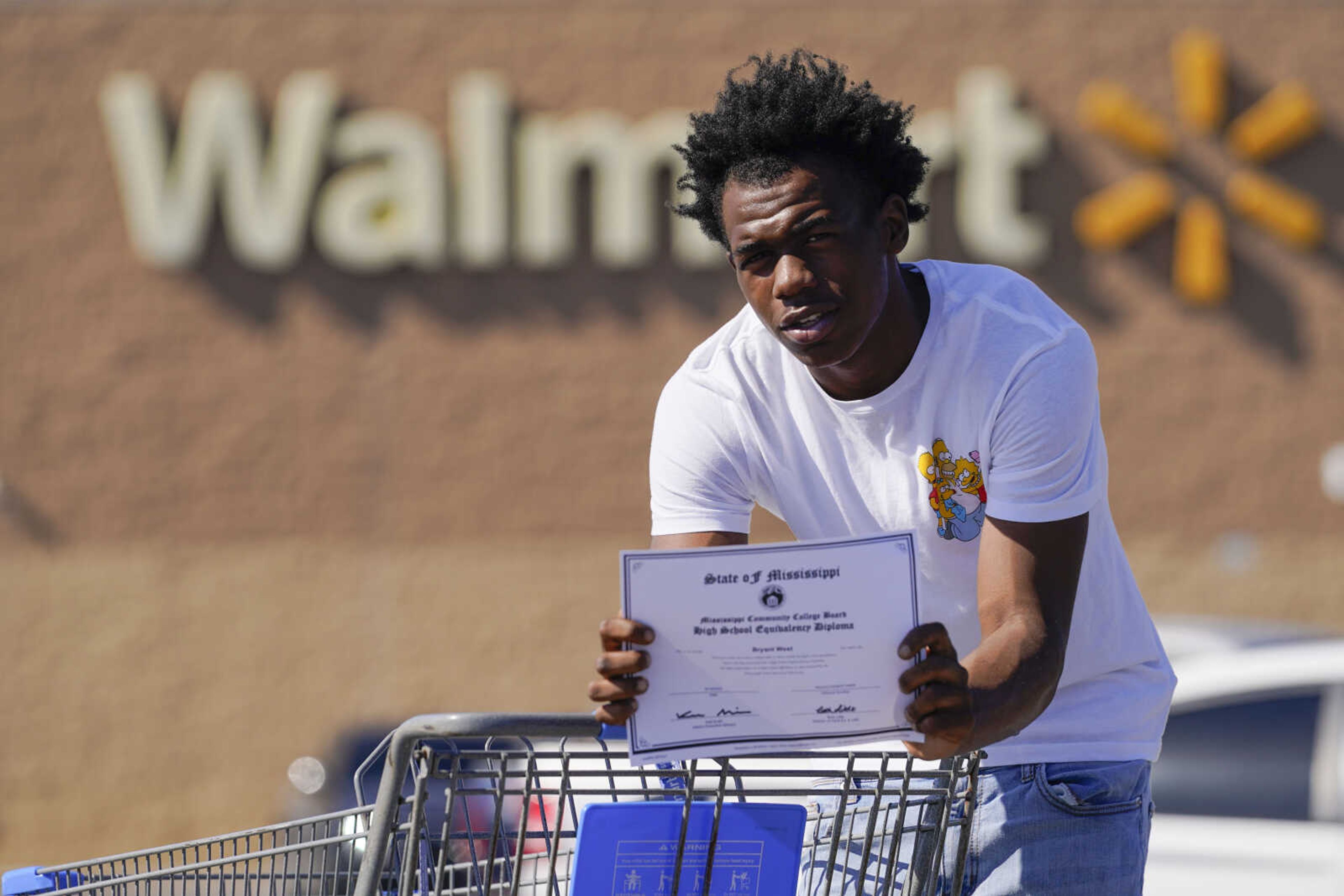 Bryant West, who has a job at a Walmart, holds a copy of his GED, as he poses for a portrait Oct. 20 in Pascagoula, Mississippi. Girls consistently are outperforming boys, graduating at higher rates at public high schools around the country. Students, educators and researchers say there are several reasons why boys are falling short.