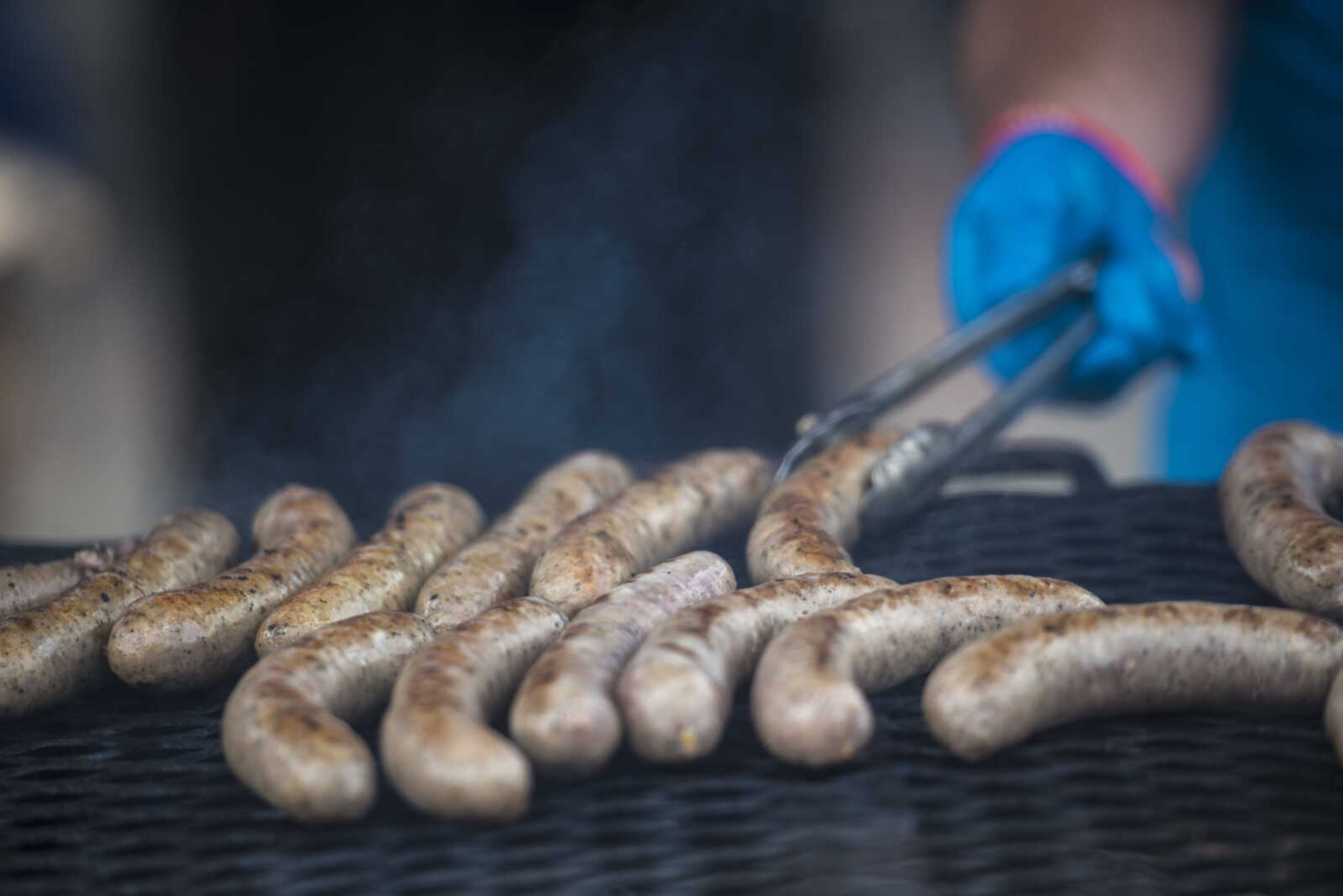 German Bratwursts are turned over on the grill at the Uptown Jackson Oktoberfest, Saturday, October 7, 2017. Christian Voight said all of his food most come off of the grill so it is fresh for the customers.