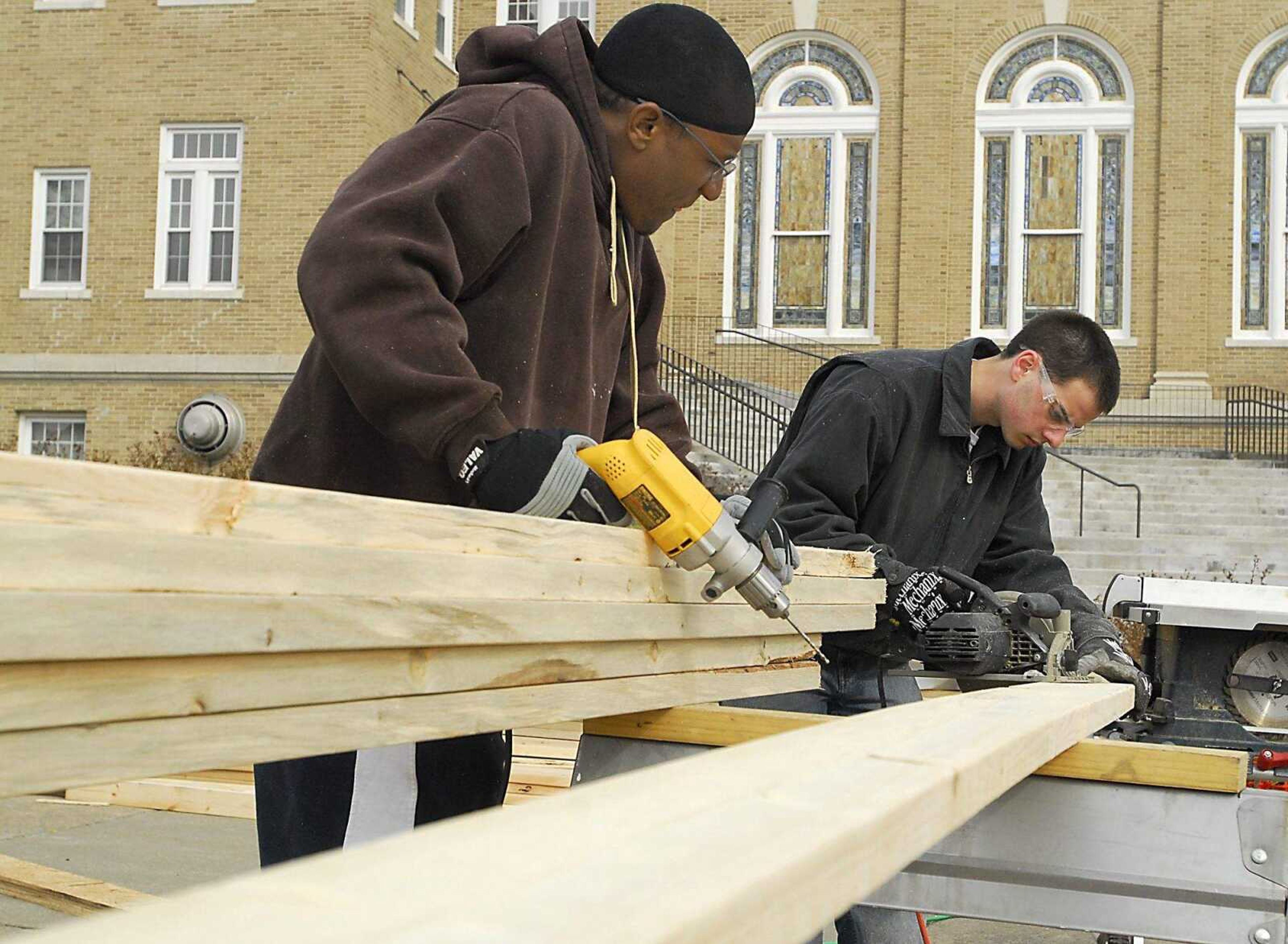 KIT DOYLE ~ kdoyle@semissourian.com
John Sterling, left, and Chris Ellis cut rafters for Sterling's future home, being built by Habitat for Humanity in the Alumni Center parking lot Wednesday, March 11, 2009, in Cape Girardeau.