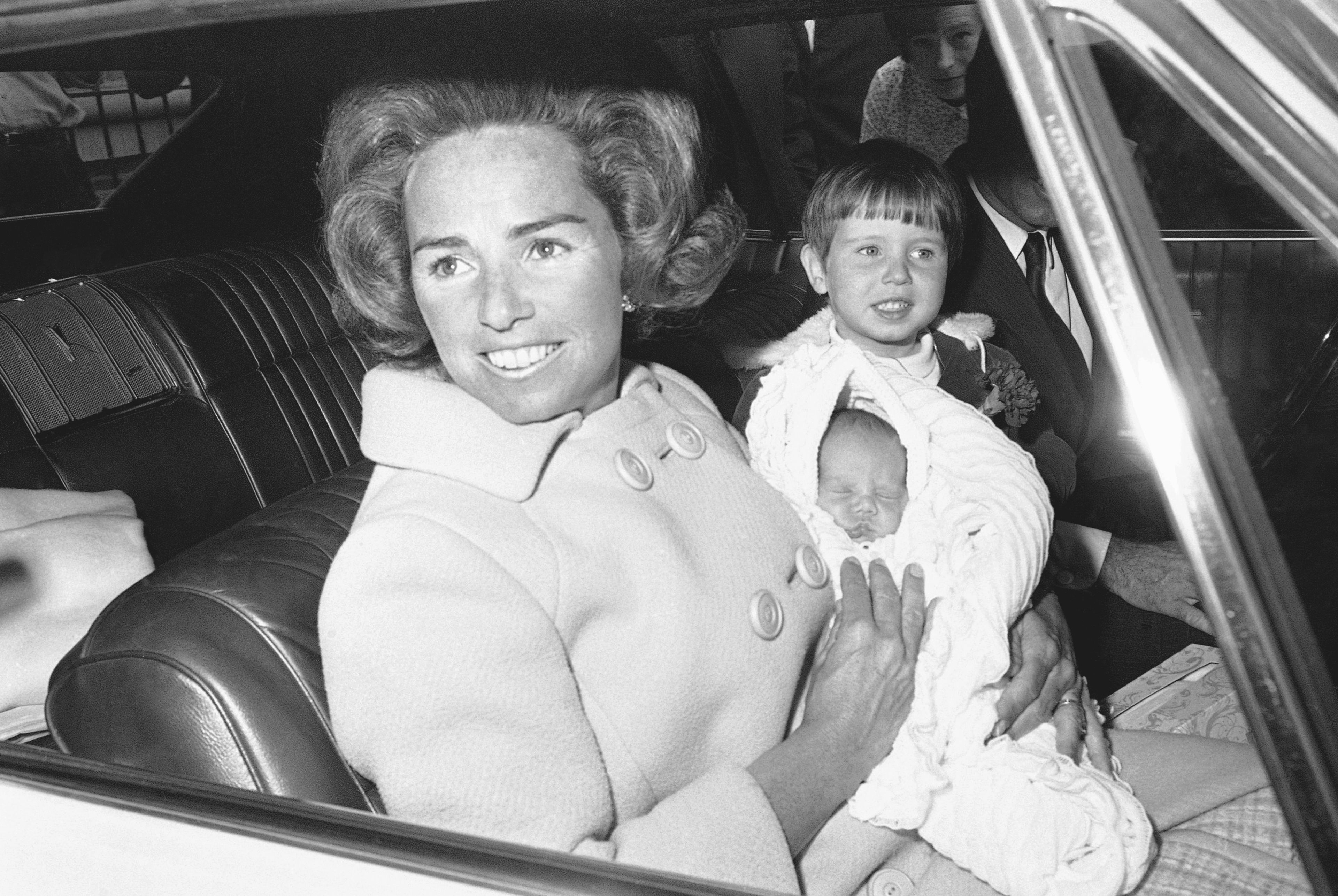 FILE - Ethel Kennedy holds her new son, Douglas Harriman Kennedy, with two-year-old Christopher Kennedy, right, as they leave Georgetown University in Washington, April 13, 1967, for home. (AP Photo/Henry Burroughs, File)