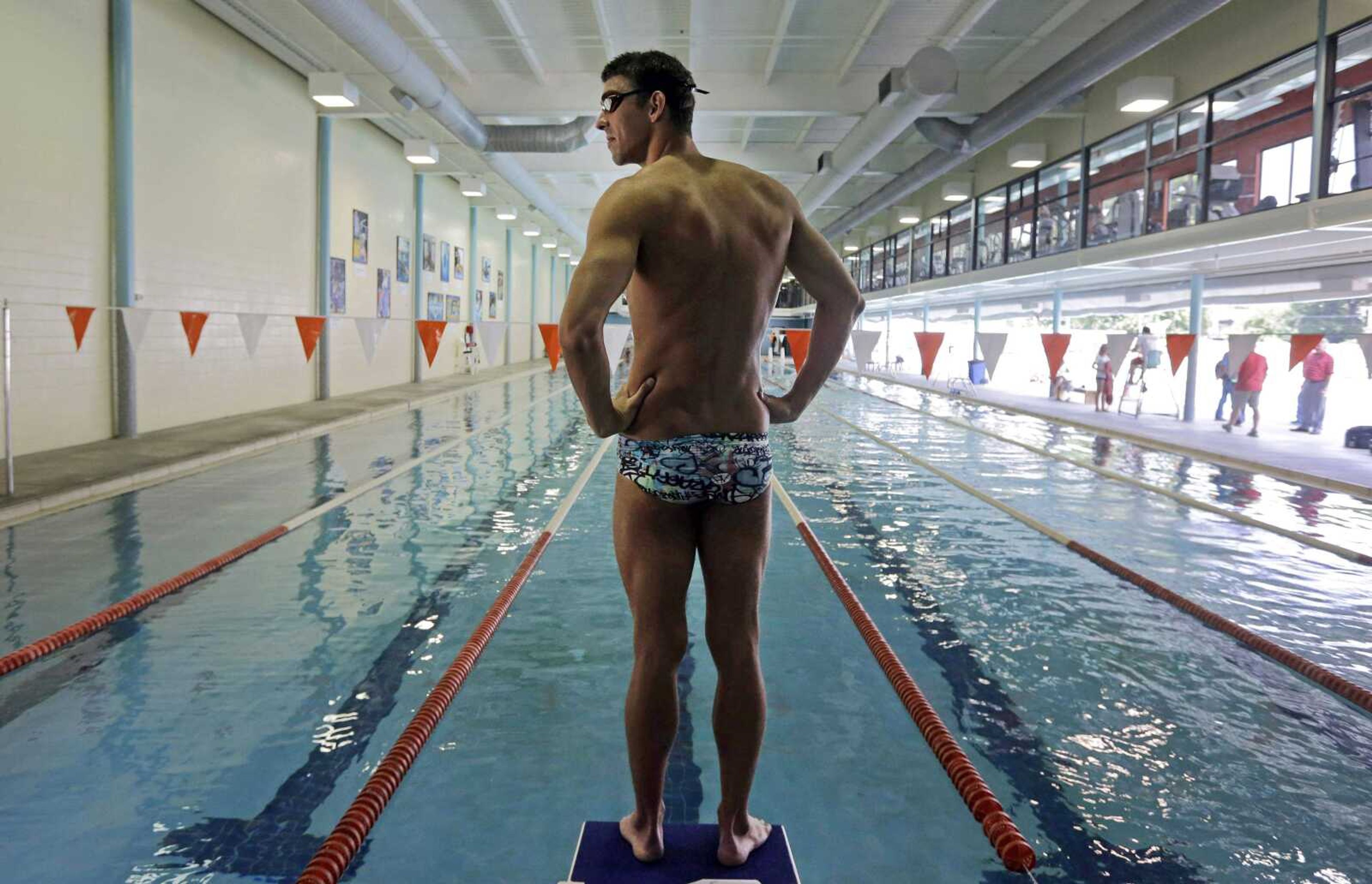 In this July 31, 2014 photo, Michael Phelps prepares to dive into a pool during a training session at Meadowbrook Aquatic and Fitness Center in Baltimore. This is where Phelps put in most of the work to become the most decorated athlete in Olympic history. This is where he's looking to add to that legacy after an aborted retirement, his eyes firmly on the Rio Games two years away. (AP Photo/Patrick Semansky)