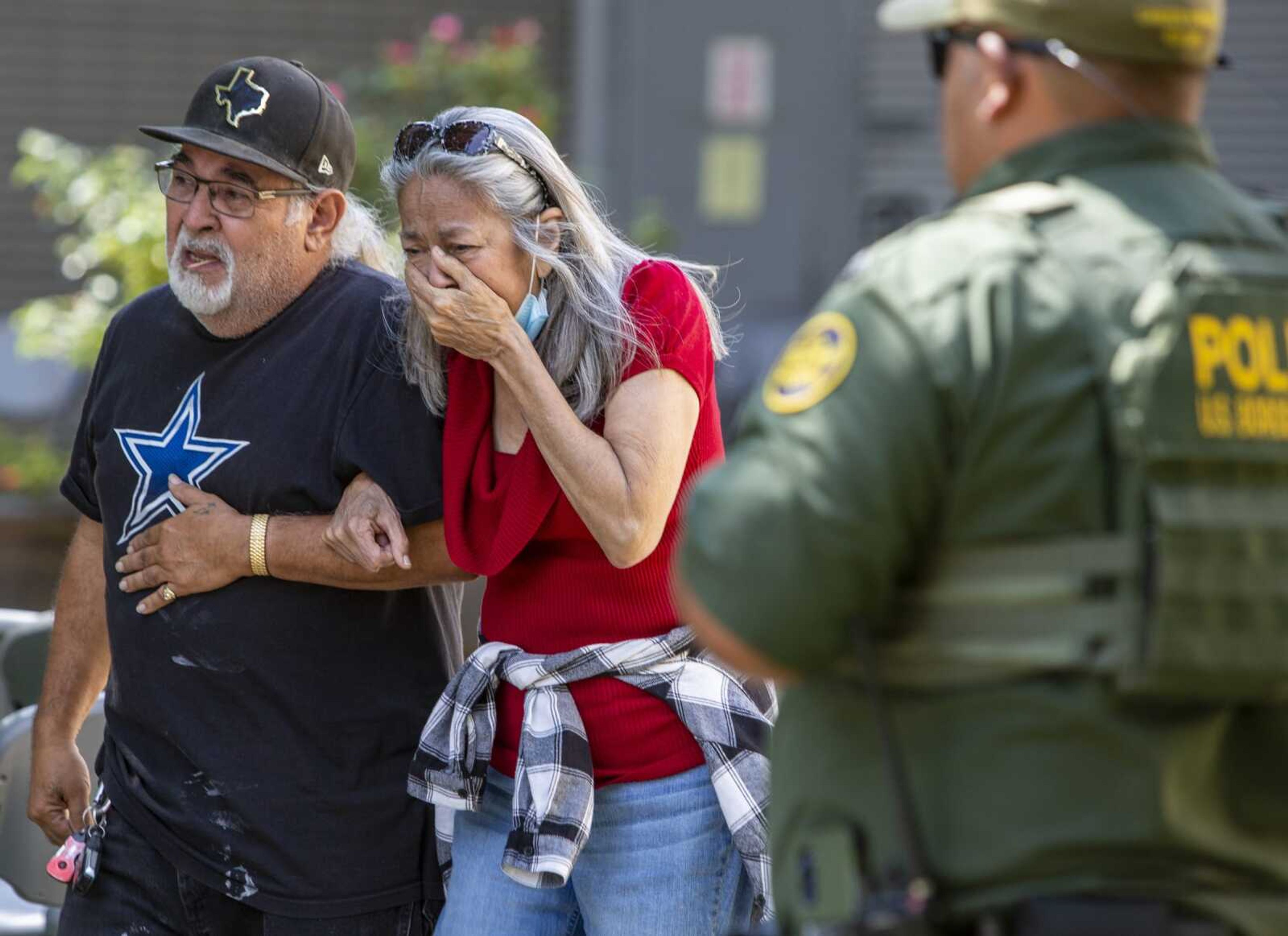 A woman cries as she leaves the Uvalde Civic Center on Tuesday in Uvalde, Texas.