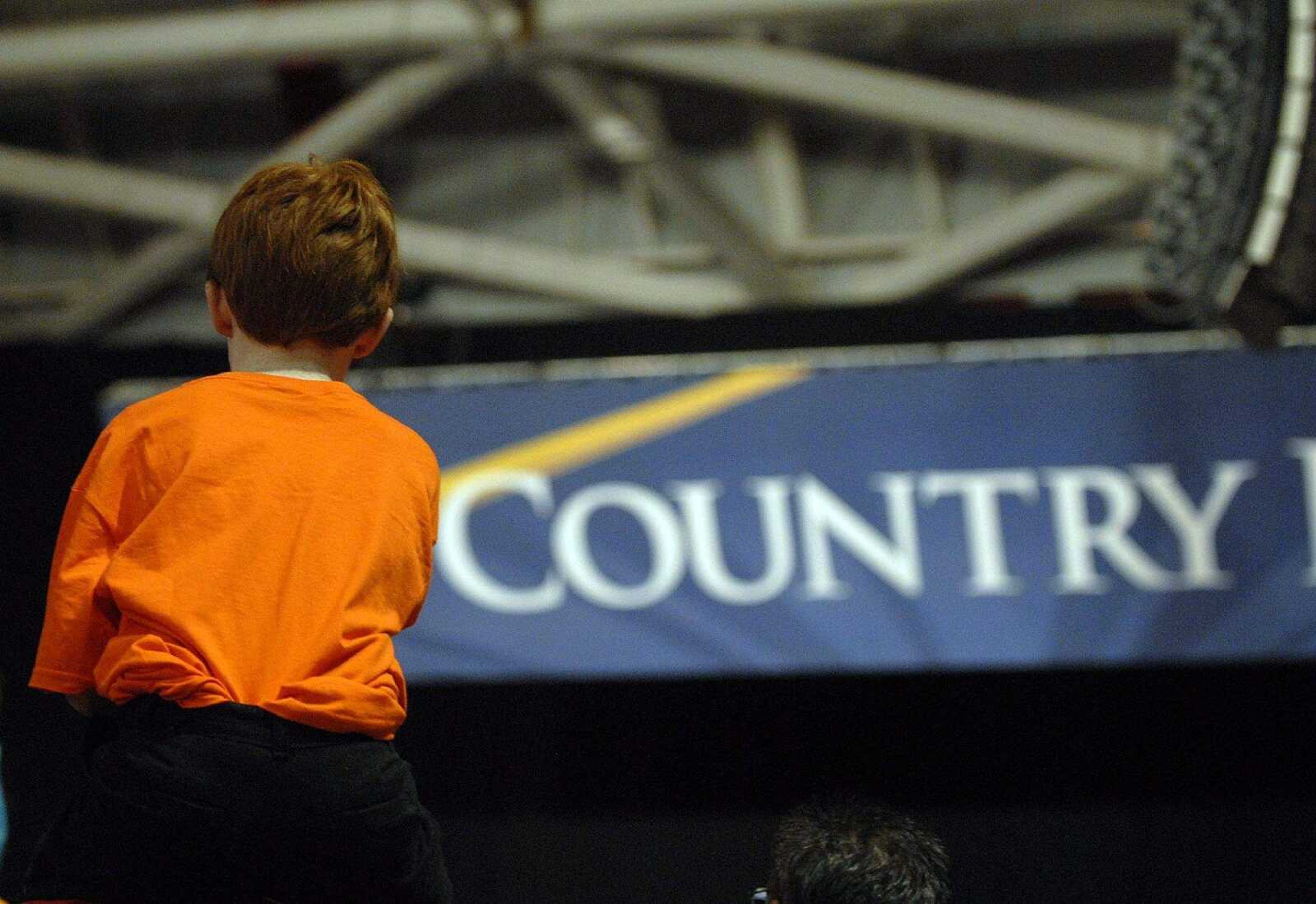 ELIZABETH DODD ~ edodd@semissourian.com
Kendall Young, 11, of Cape Girardeau, watches Gov. Sarah Palin's speech on his father's shoulders.