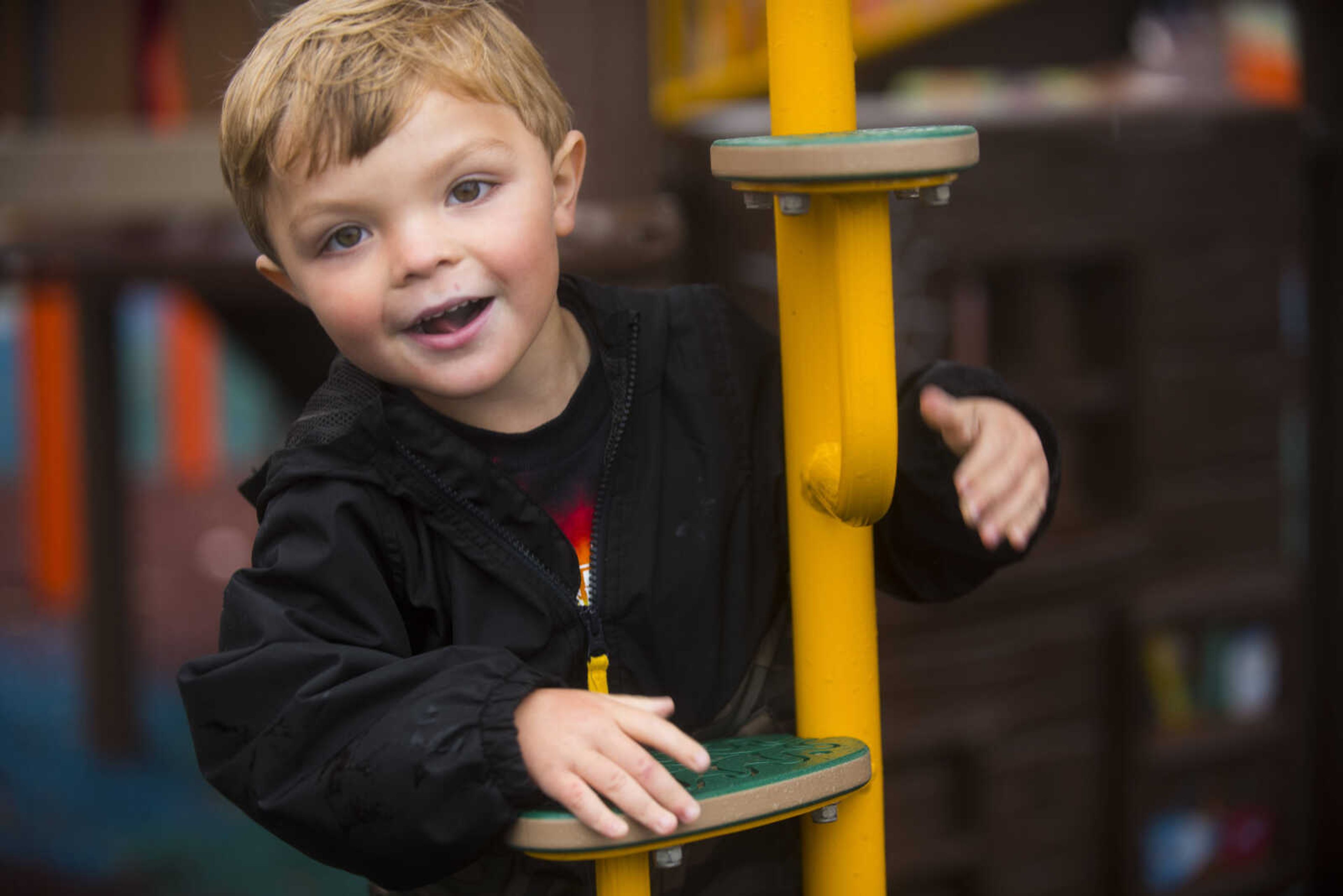 River Collom, 3, climbs on a play set during the grand opening of Levi's Adventure Trail on Nov. 5, 2017, at Cape County Park South in Cape Girardeau.