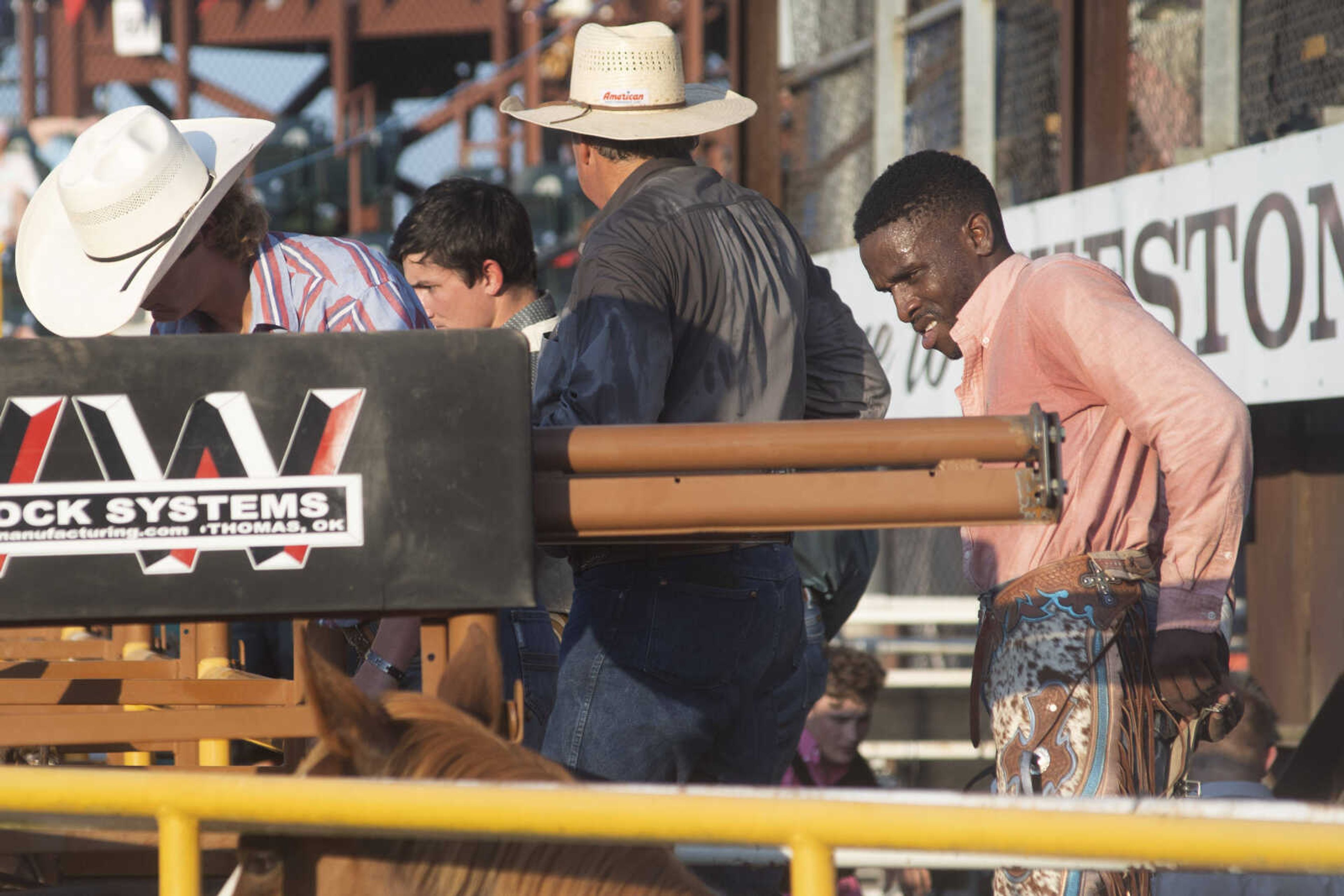 Cowboys prepare near the chutes during the Sikeston Jaycee Bootheel Rodeo on Thursday, Aug. 12, 2021, in Sikeston, Missouri.