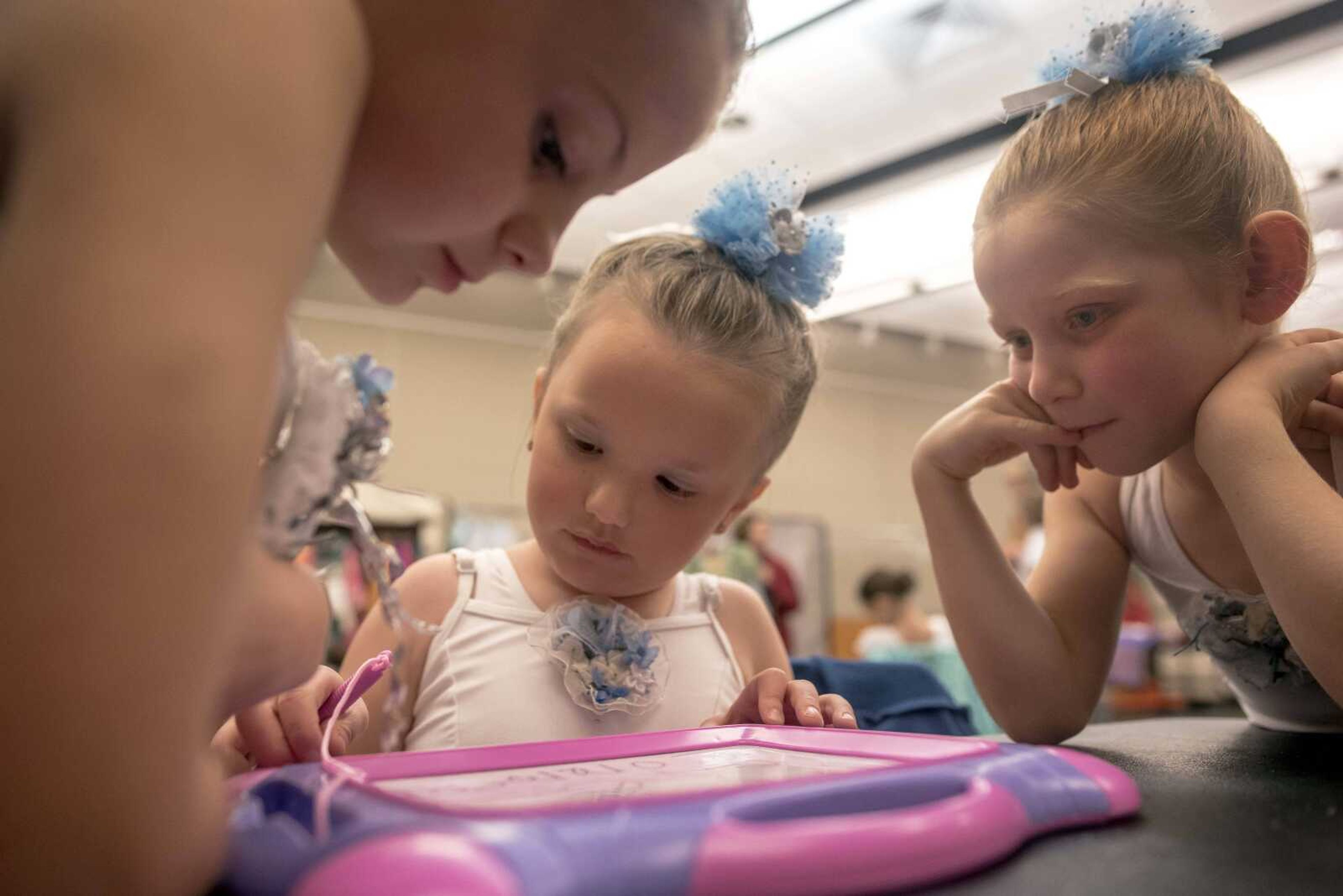 Margaret Commean, center, draws while fellow dancers look on before performing with the Moscow Ballet on Tuesday, Dec. 10, 2019, at the Southeast Missouri State University River Campus in Cape Girardeau.