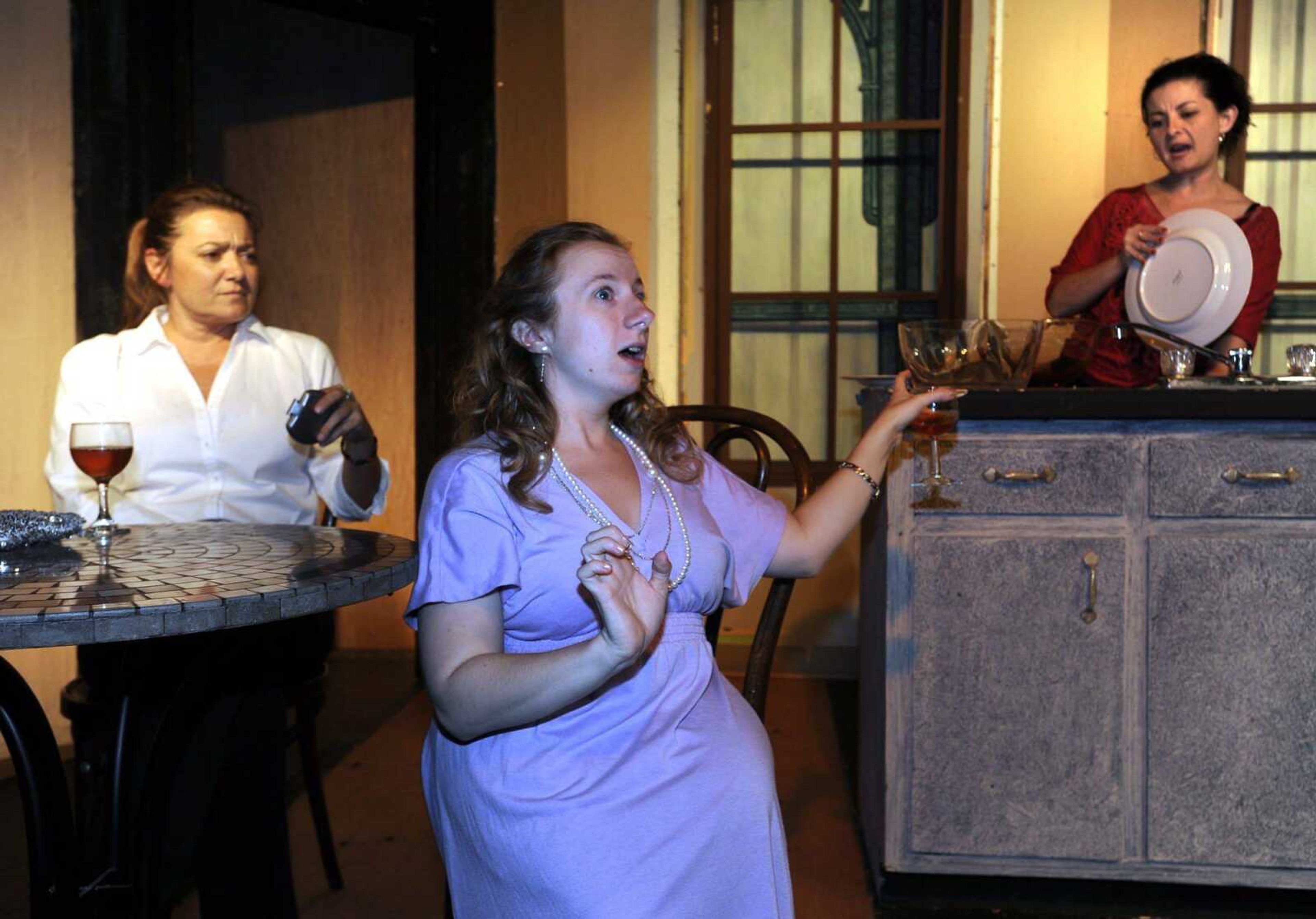 Molly, center, played by Emily Hornburg, Debra, left, played by Cynthia Luttrull, and Nicky, played by Paula McCormack, discuss living with the husbands they hate in a scene from the River City Players' production of "The Smell of the Kill." (Fred Lynch)