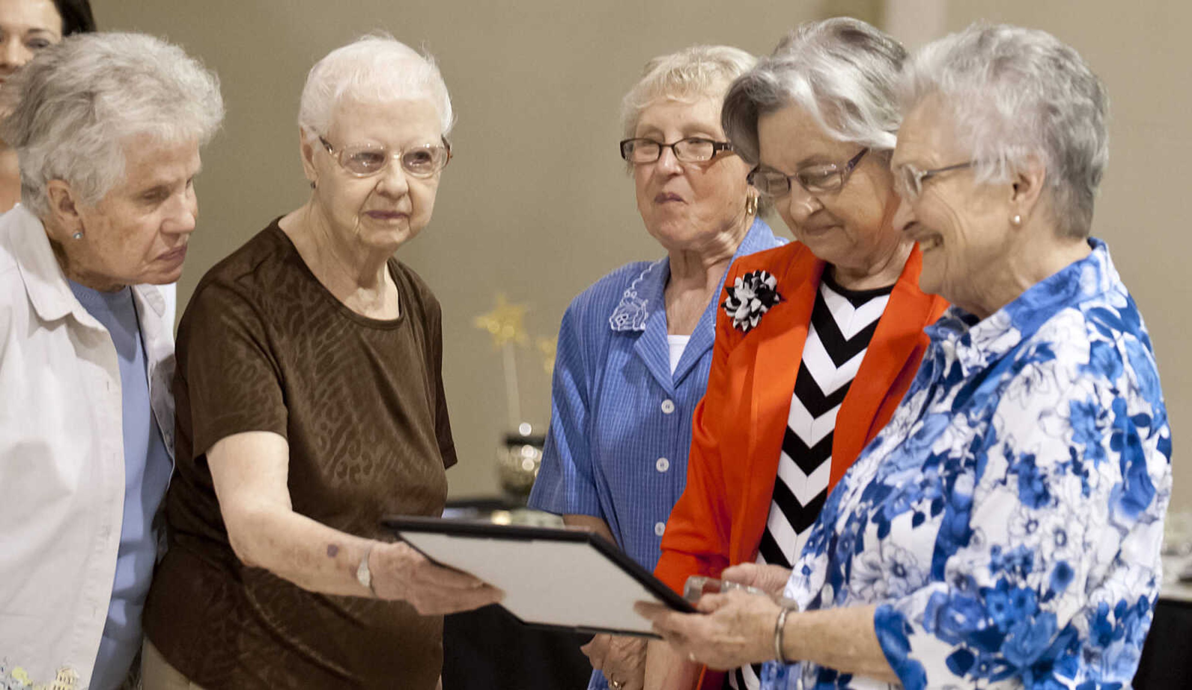 The recipients of the Shinning Star Award gather to view their award during the Cape Girardeau Salvation Army's annual dinner, "A Night with the Stars," Thursday, May 8, at the Cape Girardeau Salvation Army.